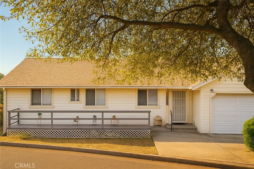 Comfortably perched above Lake Oroville, this charming 3-bedroom home offers inviting views of the surrounding hills and filtered views of the lake.  Designed with an open floor plan, this home feels happily spacious yet not ostentatious.  Its cozy living room faces the front of the home, while the family room overlooks the rear deck and yard, where the surrounding views can be enjoyed. A slider door leads from the family room to the rear upper deck, where steps then lead to the lower deck and rear yard. The kitchen offers a comfortable working design with ample storage and some pull-out drawers.  The kitchen is also central to the living, dining area, and family rooms.  The owner's suite has its own private bathroom with walk-in shower and a private exit to the rear deck.  Out back, a second lower deck also overlooks the rear yard and offers additional space for outside relaxing, bar-b-ques, etc.  The home is also equipped with central heat/air and solar.  Ideally located for easy access to the many outdoor recreational activities available including hiking, biking and horse trails, fishing, camping and boating.
