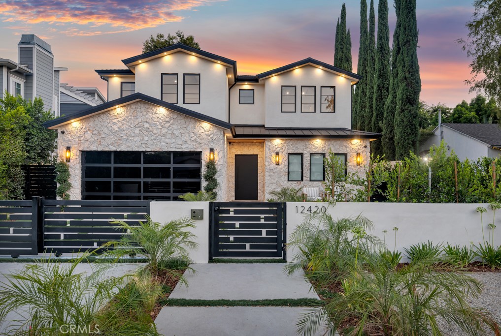 Luxurious and breathtaking New Construction estate offering 4,972 sf of meticulously crafted interiors on an 8,427 sf lot in coveted Studio City. With a striking timeless modern farmhouse architecture, and a gated entry, this residence embodies sophistication, elegance and comfort in perfect harmony. Step inside to soaring ceilings, expansive windows and wide-plank hardwood floors that bathe the home in natural light while highlighting its exquisite design details. The gourmet chef’s kitchen is a masterpiece, featuring custom cabinetry, a massive center island and top-of-the-line professional appliances. The seamless flow into the expansive dining and living areas creates the ultimate setting for both intimate gatherings and grand entertaining. Designed with versatility and modern lifestyles in mind, the home boasts a private executive office and a state-of-the-art home theater, providing both productivity and leisure at your fingertips. A fully integrated smart home system controls lighting, climate, and security, delivering effortless convenience and peace of mind. The upper level showcases four generously appointed bedrooms, each exuding comfort and style. The luxurious primary suite is a serene sanctuary with a spa-inspired bath featuring a freestanding soaking tub, glass-enclosed rainfall shower, dual vanities and an expansive custom walk-in closet. Outdoors, discover a private resort-style oasis. A sparkling pool and rejuvenating spa are framed by lush landscaping, while a covered patio and built-in BBQ kitchen provide the perfect stage for year round entertaining. Adding further flexibility and value, a detached ADU offers endless possibilities for guest accommodations, extended family or a private studio retreat. Perfectly positioned on a picturesque tree-lined street, and just moments from Ventura Boulevard’s premier dining, shopping and entertainment, this residence delivers a seamless blend of luxury, lifestyle and location.