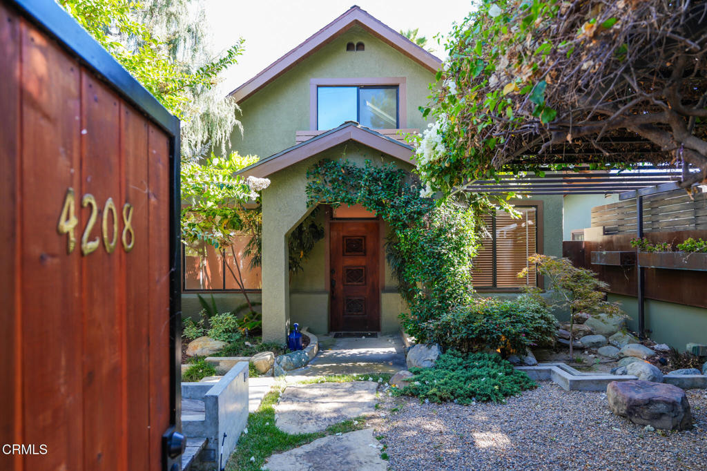 Between Los Feliz Village and Sunset Junction, just steps from coffee shops, the Metro, and Hollywood hot spots, this widely published property blends historic charm with modern design.Set within a mature, drought-tolerant landscape, native greenery and cascading wisteria create a serene welcome. Inside, this bungalow has been reimagined with an open floor plan and new floor-to-ceiling windows that flood the home with natural light and frame sweeping downtown views.The renovated kitchen features custom cabinetry, new appliances, a tiled backsplash, and granite countertops. The primary suite includes an en-suite bath and walk-in closet, offering comfort and privacy. Original hardwood floors and period details remain, balanced by thoughtful modern upgrades throughout.The large garage conversion adds valuable flexibility; currently an office/studio/gym with a full bath, equally ideal as a guest suite or in-law quarters.Main House: 4 BD | 2.5 BA | 1,850 SFGuest House: 1 BD | 1 BA | 770 SFA true work of art, this property invites you to write your next chapter in an inspiring setting.