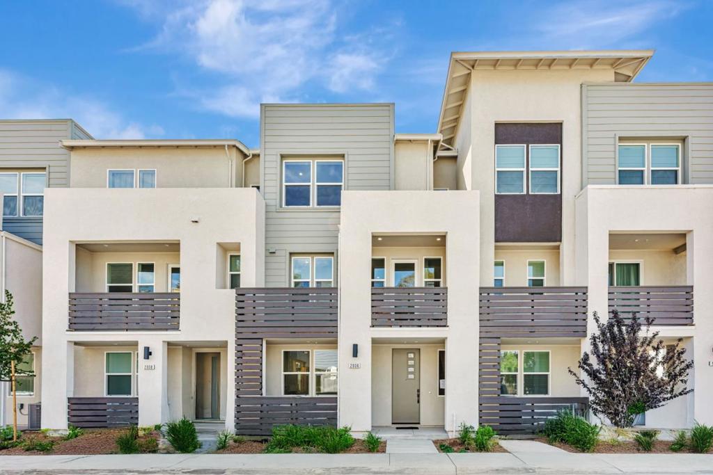 Towns Plan 3 features 4 bedrooms, 3.5 bathrooms, a 2-car side-by-side garage, quartz countertops, and Bosch stainless steel appliances. The 1st floor includes a bedroom with a private en-suite bath, ideal for guests or home office. The 2nd floor offers a great room that integrates the living and dining areas with the kitchen, creating a seamless space for everyday living and entertaining. A built-in desk adds convenience for remote work or study. The 3rd floor features three additional bedrooms, including a primary suite with a walk-in closet. Energy efficiency is enhanced with solar panels, which can be leased or owned. This home is available for quick move-in. Ownership is condominium. City Village by Summerhill Homes features 404 elegant residences and a 2-acre public park with walking, biking trails, seating areas, and a community BBQ spot. Located near San Ramon's City Walk Neighborhood and within walking distance to City Center restaurants, movie theater, and retail shops, the community offers convenient access to amenities. Designed for easy access to schools, work, and public transit, City Village is near Central Park, Canyon Lakes Golf Course, and Bridges Golf Club. The provided images reflect the actual home and interior. Visit our Sales Office today to tour home.