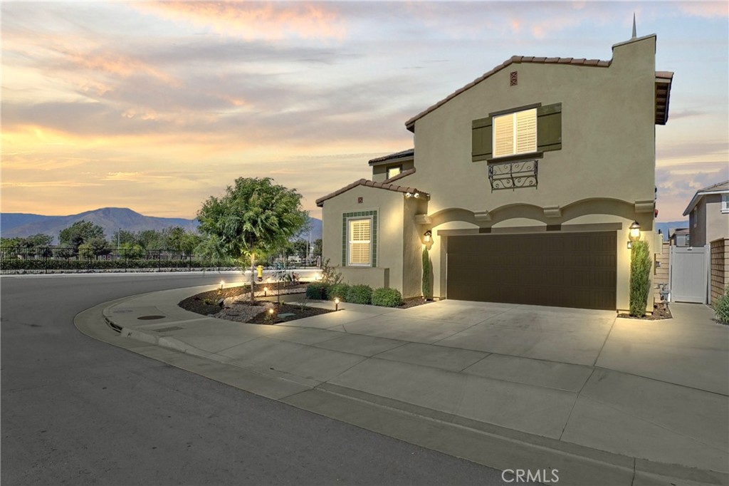 Welcome to this stunning 2022-built home nestled in the highly desirable Lennar Master Community at Traditions of Redlands. Experience modern living in this meticulously renovated home, perfectly situated on a quiet CORNER Prime Lot. With many high-end upgrades, this compound feels just like a Model Home. The extended custom driveway and walkway front entrance, along with a professionally landscaped front yard, enhance the home’s inviting, gorgeous curb appeal. As you step inside, you're greeted by an open, airy layout anchored by a bright living room showcasing soaring high ceilings, recessed lighting, luxury flooring, and a sophisticated custom light fixture. Featuring 4 Bedrooms, including a versatile Main-Floor room ideal for guests or a private home office and 2.5 bathrooms, this home is perfect for growing families. The entire space is filled with natural light that beams through energy-efficient windows adorned with elegant plantation shutters.
The living area flows effortlessly into a stylish dining space and a Modern Kitchen featuring stainless steel appliances, quartz countertops, an oversized Center Island, crisp white cabinetry, and a walk-in Pantry perfect for the avid home chef. A sliding glass door leads to an entertainer's dream private backyard with top of the line Stamped Concrete flooring, built-in lighting along the retaining planter, and ample space to enjoy the California weather.
Ascend the beautifully crafted staircase upstairs to find a spacious Loft, Two generous Bedrooms, a Full Bathroom with a tub, a Walk-in linen closet, and a Laundry room with extra storage cabinetry. The expansive Primary Suite Bedroom offers a luxurious escape, complete with a large walk-in shower, dual vanity sinks, and a generous walk-in closet, ensuring comfort and convenience every day. Park your vehicles inside the fully finished two-car garage with Epoxy Flooring and Hexagon ceiling lights. Modern energy-efficient technology features include Fully Paid OFF SOLAR panels, a tankless water heater, and a smart home security system. With Low HOA fees, access to a community park and playground, and a prime location close to shopping, freeways, and entertainment, this model-like home surrounded with serene scenery - truly has it all. This is a rare opportunity you won’t want to miss.