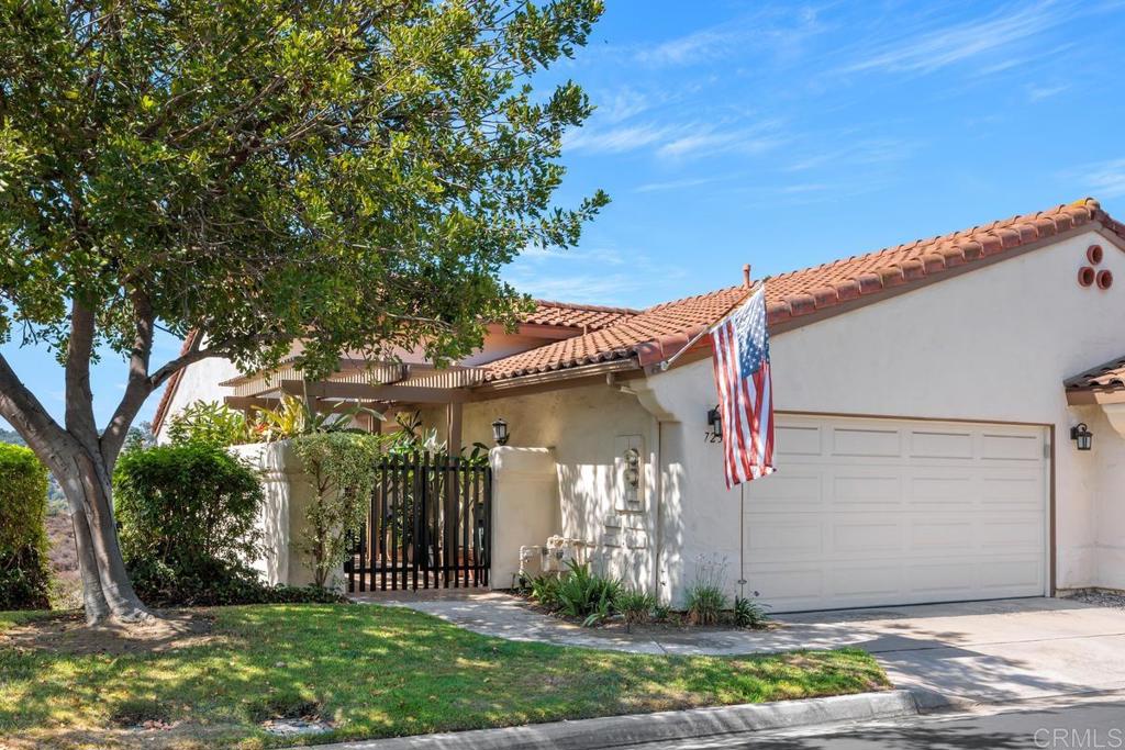Welcome home to this beautifully updated condo tucked inside a gated community in South Escondido. This unique split-level floorplan offers main living spaces on the entry floor, with all three bedrooms located downstairs for added privacy and tranquility. An upstairs office adds flexibility for remote work, creative projects, or guest use. Enjoy sweeping views of the surrounding valley and mountains from the living areas, back deck, and lower patio—ideal for morning coffee or evening relaxation. The spacious living room features a custom stone fireplace with a handcrafted mantel, adding warmth and character to the heart of the home. Hardwood flooring runs throughout the main living areas, with soft carpeting in the bedrooms. The kitchen includes stainless steel appliances, generous counter space, and a functional layout perfect for both everyday living and entertaining. Thoughtful updates include Milgard windows and doors throughout, an updated front door with locking screen, and a secondary sliding door with built-in blinds in the secondary office area. The electric window shades in the living and dining rooms offer light control with ease. Outdoor spaces are just as impressive, with Trex decking in both the front and backyard, aluminum patio covers for year-round shade and rain protection, and a beautifully finished brick patio just off the guest and primary bedrooms. The primary suite features an updated bathroom with a large walk-in shower, and the secondary bathrooms have also been tastefully remodeled. Community amenities include a sparkling pool, tennis courts, and scenic walking paths—all just minutes from schools, shopping, and parks.