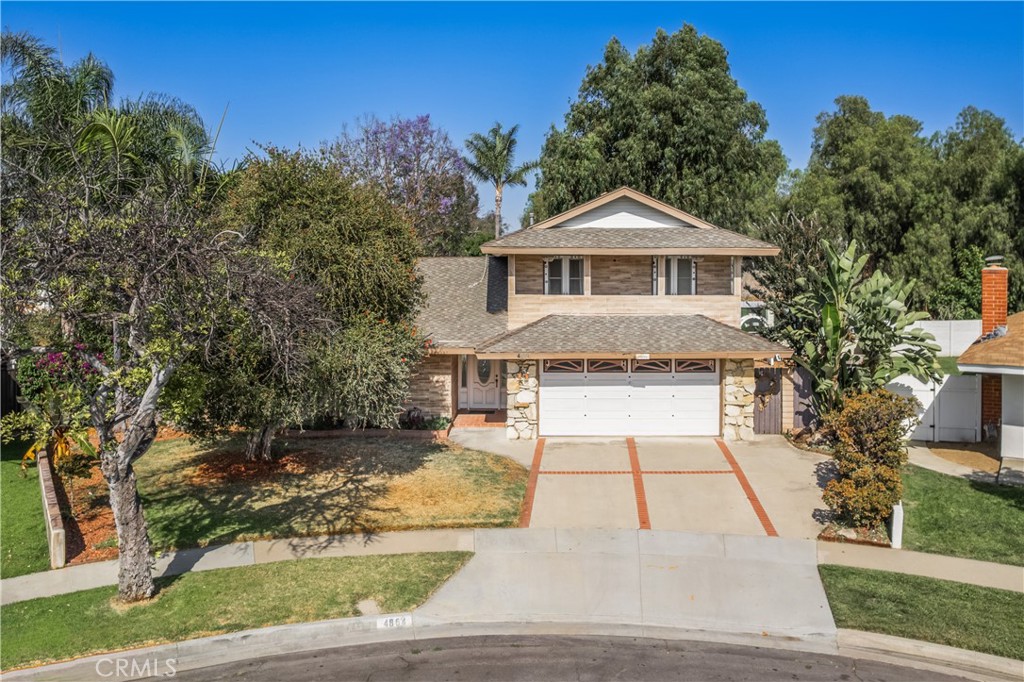 Opportunity Awaits in Anaheim Hills! Tucked at the end of a quiet cul-de-sac, this 4-bedroom, 2-bathroom home offers 1,667 sq. ft. of living space on a generous 7,650 sq. ft. lot — a rare combination of privacy, flexibility, and potential. The layout includes a convenient downstairs bedroom and full bathroom, ideal for guests, extended stays, or anyone who prefers main-level living. Upstairs, two bedrooms open to a spacious private balcony, offering a calm outdoor space with a sense of privacy and elevation. The living room features a cozy fireplace, creating a warm and inviting space to relax or entertain. Outside, the expansive backyard is framed by mature trees and includes a shaded patio with pergola—perfect for outdoor dining, gardening, or future customization. The oversized, pie-shaped lot offers exceptional privacy and room to grow. While the home is ready for your personal touch, it provides a solid foundation and excellent layout to build upon. Located near parks, schools, and with easy access to the 91 and 55 freeways, this home offers both comfort and convenience. Don’t miss your chance to make 4864 McKinnon Dr your own—schedule a tour today!