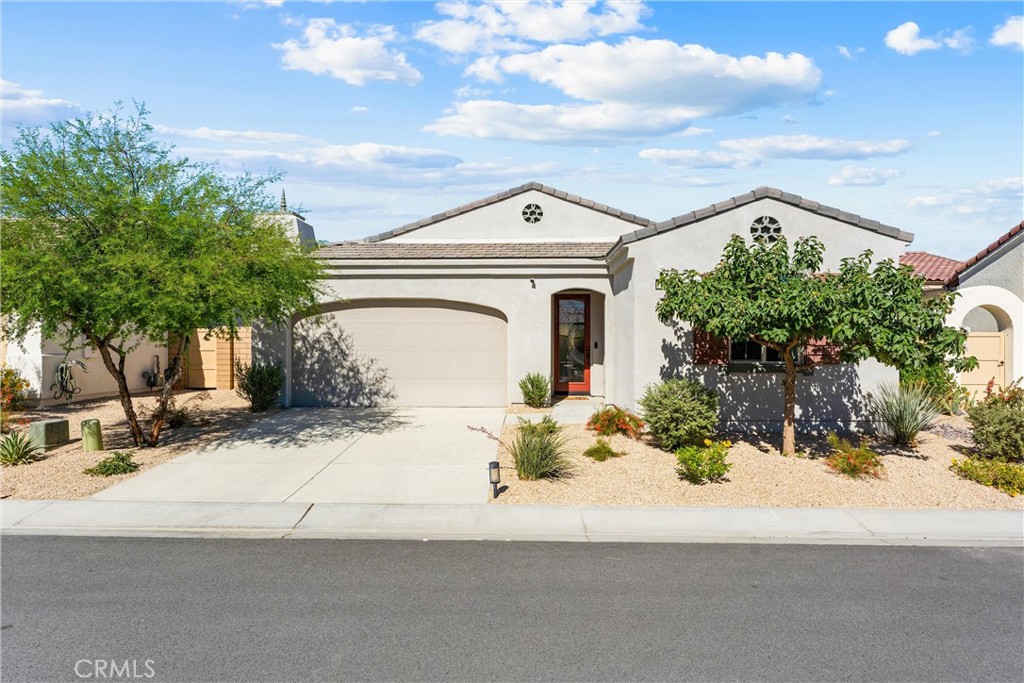 Welcome to your desert dream home! This beautifully upgraded single-story showplace with its own private pool with a baja self and umbrella providing that perfect lounge area offers incredible value and resort-style living in the highly sought-after 55+ gated community of Domani.
From the moment you open the custom front door, you’re greeted by natural light, stylish finishes, and an open, inviting layout. The modern kitchen features gorgeous cabinetry, stunning countertops, and a large island that seamlessly connects to the dining and living areas—perfect for entertaining or relaxing in style.
The spacious primary suite is a tranquil retreat with a beautifully upgraded, spa-inspired bathroom. A second bedroom, which is a junior primary suite with its own en-suite provides privacy for guests, while the den/office offers flexibility for work or hobbies. The custom-tiled powder room and inside laundry room complete this ideal floor plan.
Step outside to your own private oasis—complete with a sparkling custom pool, soothing water feature, and a covered outdoor lounge with a ceiling fan and TV for year-round enjoyment. The turf area is perfect for pets or even a personal putting green! The garage is finished with epoxy flooring and custom cabinetry for extra storage.
Enjoy all the resort-style amenities Domani has to offer, including a beautiful clubhouse, fitness center, pool, spa, outdoor lounge with fireplace and TV, outdoor seating area with a fire feature, dog park, pickleball, and bocce ball.
A spectacular home, with over $75,000 in upgrades, in a vibrant community—this is the one you’ve been waiting for!