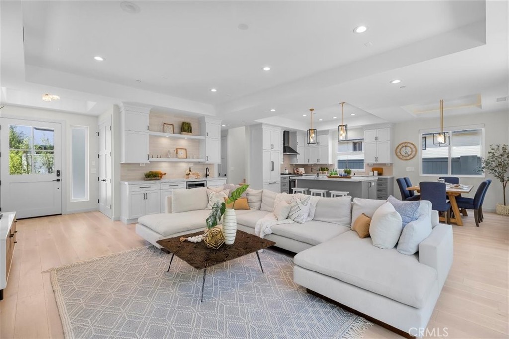 Step into modern luxury with this exquisitely crafted, built in 2022, 4 bedrooms, 3.5 baths, 2,662 sq. ft., detached townhome. Where thoughtful design and high-end finishes come together to create the perfect living space.
Enter the home and immediately notice the high ceilings and abundance of light. The extra wide plank white oak engineered hardwood flooring throughout the home adds a touch of warmth and sophistication. The open concept living/dining room features high ceilings, a modern fireplace and flows seamlessly into the gourmet kitchen. Equipped with top-of-the-line appliances, custom cabinetry, elegant quartz countertops, farmhouse sink and a large island with counter seating, this kitchen is a chef’s dream. This will be the primary gathering spot during parties and holiday celebrations or just everyday living. Step outside to the sunny, private back yard, it’s easy to imagine the summer BBQ’s you will enjoy here.
Upstairs, you will find a second versatile living area, perfect for home office, media room, relaxation or doing school work. The grand primary retreat impresses with vaulted ceilings, a cozy fireplace, sitting area, a private balcony and a custom walk-in closet. The spa-like bathroom will leave you feeling pampered with its freestanding tub, large shower and double sinks. Three additional spacious bedrooms are located upstairs each with an adjoining bath, providing plenty of space for family or guests. Enjoy coastal living in this luxurious townhome. You’ll be close to top-rated schools (Jefferson Elementary), freeways, LAX and of course, the beach.