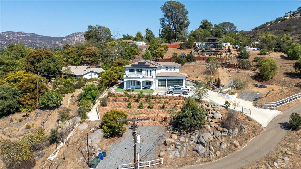 Welcome to your new dream home in the heart of beautiful Rancho San Diego. This stunning new construction, built in 2023, is a masterpiece of modern design and thoughtful engineering. The extensive grading of the potential lot has resulted in a spectacular, elevated setting with breathtaking views. Step inside and be prepared to be wowed by the grand 22-foot high ceilings, creating an expansive and luxurious feel throughout. The entire home is laid with beautiful tile flooring, offering a sleek, clean look and exceptional durability. The main floor features a private, downstairs master suite, complete with a lavish en-suite bathroom that serves as your own personal sanctuary. This home seamlessly blends legacy craftsmanship with cutting-edge, modern features, including a dedicated upstairs laundry unit for ultimate convenience. To top it all off, the fully owned and paid-off solar system ensures a life of sustainable luxury, with minimal energy costs and maximum peace of mind. This is more than just a home; it's a statement of style and a testament to quality in one of the area's most beautiful and sought-after communities.