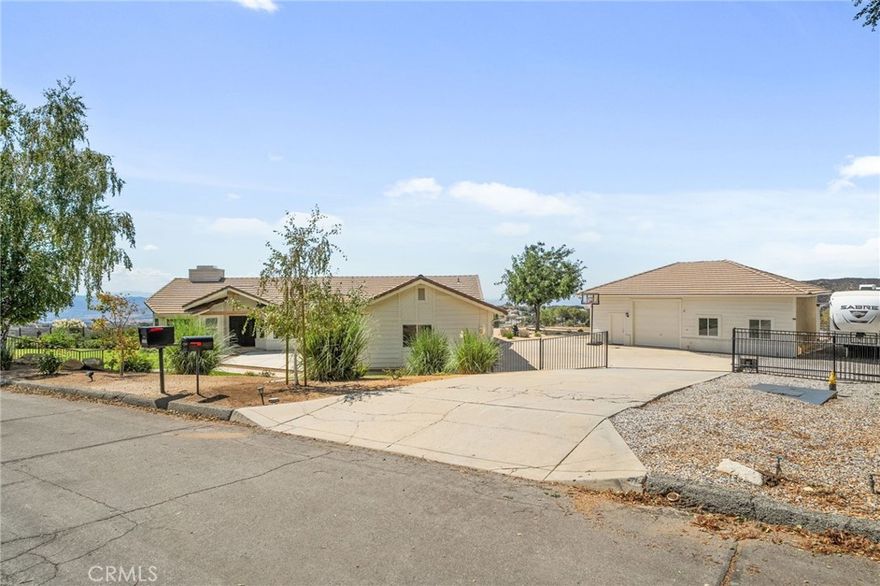 Elevated living inside and out! Serenity IS this single level home perched at the top of Yucaipa on the crest of Oak Glen apple country! You must EXPERIENCE Oak Crest in person to appreciate its magic! To feel the warm sun beams flooding the home with natural light throughout. To hear the hum of nature and only nature as you soak in VIEWS of Magnificent Sunsets transcending to Magical Evening City Lights. What you won't hear is your partner tinkering on their muscle car because in addition to your 3 car attached garage, lies their very own 1200 square foot detached garage separate from your gorgeous peaceful home! TWO GARAGES can you believe it?! Everyone will love this 4 bedroom 3 Bath, open-concept layout offering soaring ceilings and expansive windows with two living areas and modern fireplace. Custom blinds, electric sliders, ceiling fans, recessed lighting, new luxury vinyl flooring, windows, cabinetry, and fixtures create a move-in ready experience. The chef’s kitchen features striking quartz countertops with waterfall island, soft-close cabinets, a farmhouse sink, and upgraded appliances. The executive suite is a true retreat, with panoramic windows framing unforgettable sunsets. Its spa-like bathroom showcases elegant tilework, a soaking tub, walk-in shower, dual vanities, and a spacious walk-in closet. Three additional bedrooms feature fresh carpet, generous closets, and ceiling fans. Enjoy Two additional upgraded bathrooms inside as well as laundry room with built-ins, farmhouse sink, and backyard access add style and practicality. Step outside to your backyard oasis with new synthetic turf and two covered patios—perfect for enjoying sweeping sunrise-to-sunset views. Car enthusiasts will love the attached 3-car garage with custom cabinetry and tankless water heater, plus a detached 1,200 sq. ft. garage with epoxy floors, office, bathroom, and drive-through roll-up doors. RV and boat parking with hookups and a dump station, all privately gated, ensure every need is met. Pristine landscaping enhances curb appeal, while the expansive lot offers room to grow—whether adding an ADU, cultivating a garden, or creating your own farmstead. Located in prime Upper Yucaipa, minutes from Oak Glen’s apple country, this home offers elevated mountain living with modern convenience. Don’t miss your chance to call it your own—schedule a private showing today.