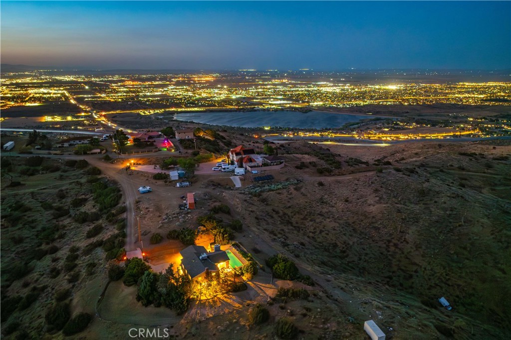 ***LIVE BAEUTIFULLY*** Custom-Built, One-of-a-Kind 4 Bedroom, 3 Bath Pool Home with Breathtaking Mountain, City, and Lake Views! Perched near the top of the highly sought-after Tierra Subida neighborhood, this stunning custom-built home offers over 3,000 sq. ft. of uniquely designed living space and unforgettable panoramic views of the mountains, city lights, and lake. From the moment you arrive, you'll be captivated by the home's elevated position and its striking architectural presence. Step inside to discover a thoughtfully crafted layout with luxurious details throughout, including fresh paint, elegant crown molding, plantation shutters, recessed lighting, and new luxury vinyl plank flooring. The spacious family room features a cozy pellet fireplace and oversized windows that perfectly frame the spectacular scenery and invite natural light into the home. The remodeled chef’s kitchen is an entertainer’s dream, boasting granite countertops, a large pantry, tile flooring, an expansive breakfast bar, a center island (included), and a stainless steel LG refrigerator that stays with the home. The adjacent formal living room offers the second of three fireplaces, adding warmth and charm to every gathering. Downstairs includes a versatile converted bonus room that could serve as a 5th bedroom, office, or guest space. Upstairs, you’ll find a generous loft with its own fireplace and direct access to a private balcony—ideal for enjoying those stunning views day or night. The primary suite is a tranquil retreat, complete with a recently updated ensuite bathroom and a luxurious walk-in shower. Three additional bedrooms and a full bath round out the upper level. Step outside to your private backyard oasis, complete with a large in-ground pool and spa, a covered patio for shaded relaxation, and patio furniture that stays. It’s the perfect setting for entertaining or simply soaking in the awe-inspiring scenery. Tucked away in a peaceful and private setting, yet just minutes from freeway access, this custom masterpiece truly offers the best of both worlds.