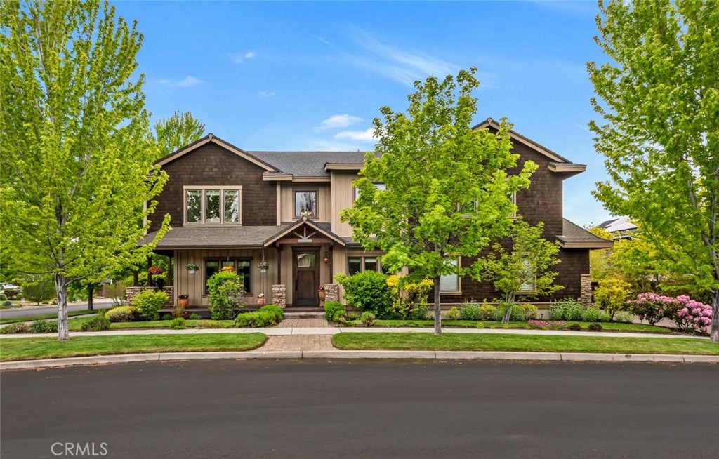 Step inside this unforgettable Northwest Craftsman and feel the difference—this is no ordinary home. With Tour of Homes-level craftsmanship and rich upgrades throughout, every detail has been thoughtfully curated to impress. The entry alone makes a statement, opening to hand-troweled walls, travertine stone floors, and eight-foot alder doors that guide you through soaring ceilings and sunlit spaces. The kitchen is the heart of it all: oversized island, dual-fuel range, custom alder hood, and a built-in paneled fridge that blends seamlessly into warm, wood-rich cabinetry.Gather around one of the three stone fireplaces or retreat to the spa-like primary suite with a jetted tub and walk-in shower. Upstairs, enjoy a cozy loft library, a bonus room perfect for movie nights, and two additional bedrooms. The main-level office easily flexes as a fifth bedroom. Outside, mature landscaping and a cascading three-tier waterfall frame a tranquil eco-pond—perfectly private yet close to the park