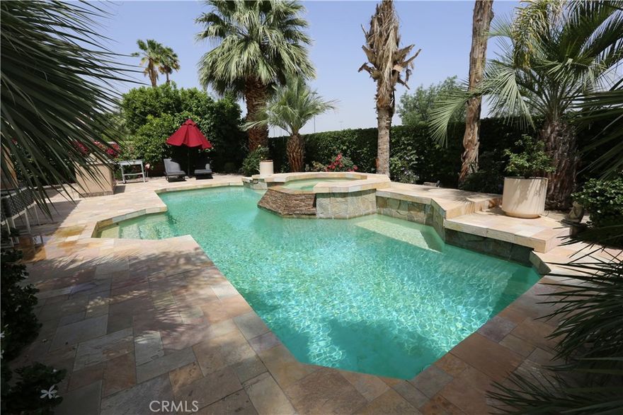 Single-level desert retreat with a detached casita, pool, and a 3-car garage in the gated Lantana community. Behind a private, palm-lined courtyard, this ~3,322 sq ft home blends indoor-outdoor living with soaring ceilings, a fireplace-anchored great room, and wide views to the backyard oasis. The island kitchen features generous counter space and bar seating that opens to casual dining and family lounge areas—ideal for entertaining. The split floor plan offers a tranquil primary suite with direct patio access, spa-size bath, and walk-in closet; two secondary bedrooms share a Jack-and-Jill bath; and the separate casita creates perfect guest, office, or multi-gen space. Outside, enjoy a resort-style pool with waterfall, sun patios, and low-maintenance desert landscaping. Additional highlights include a powder bath, laundry room, and abundant storage. Low HOA dues in a quiet cul-de-sac community near El Paseo shopping/dining, golf, and year-round events.

4 bedrooms including casita | 3.5 baths (public records) | built 2000 | ~10,454 sq ft lot | 3-car garage | Subdivision: Lantana.