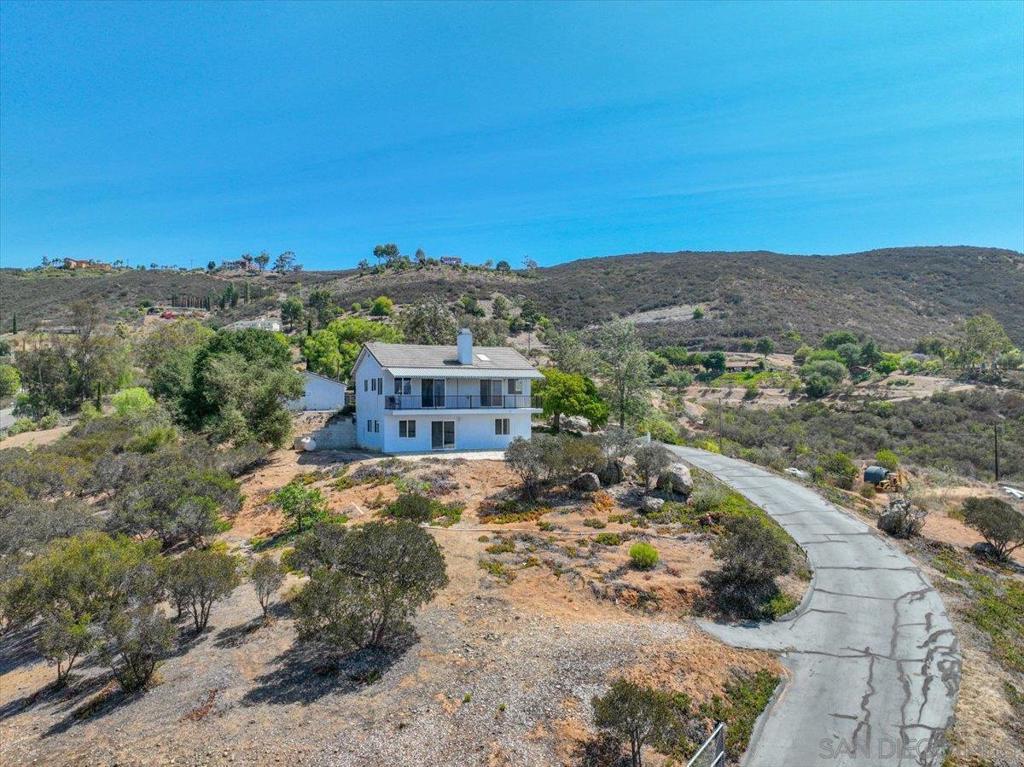Welcome to 13622 Coyote Vista Way in Jamul. Perched on a private hilltop, this 3-bedroom, 2.5-bath residence offers breathtaking 180-degree views of the surrounding rolling hills. With 1,750 sq. ft. of living space, the home features an open floor plan, abundant natural light, and seamless indoor-outdoor flow. Perfect for investors or home buyers looking to make it their own. A spacious 3 car garage and additional work shed provide ample storage and workspace. Sitting on 3 acres, the property offers plenty of parking and room to spread out, all while maintaining unmatched privacy. A rare opportunity to enjoy peaceful country living just minutes from town.