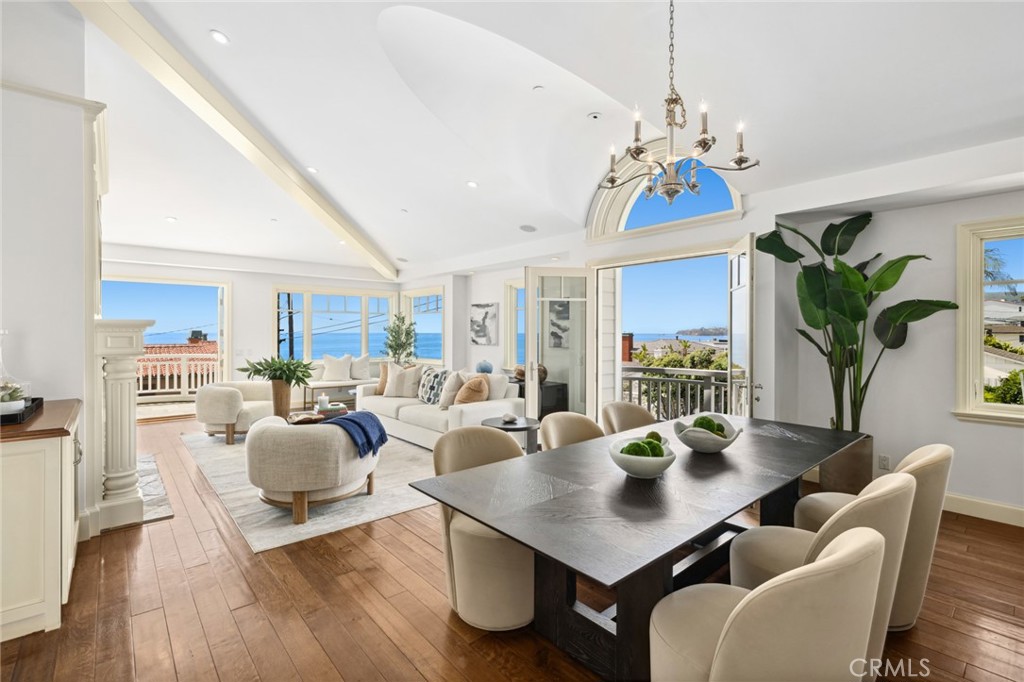 Panoramic ocean, whitewater, north-coast city-light, and Catalina sunset views fill almost every room of this luxurious Laguna Beach home with an enchanting ambiance that redefines the magic of indoor/outdoor living. A prime second-row corner homesite offers an exceptional location in Laguna Village that boasts a rare opportunity to indulge in oceanfront living without the oceanfront price. Uniquely positioned just a few yards from the beach, the New England Coastal-style residence enjoys an unobstructed vantage point that feels like a front-row setting and provides a relaxing and sophisticated lifestyle. Extending approximately 3,660 square feet and home to three ensuite bedrooms, five baths, and flex space for an additional bedroom, the extra open and bright design is bathed in an abundance or natural light and maximizes ocean views. The main level generously caters to entertaining in one vast open floor plan that includes an elegant fireplace and a professional-grade designer kitchen with top-of-the-line appliances including a Sub-Zero refrigerator, Sub-Zero refrigeration drawers, and a six-burner double-oven Dacor range. The ocean-view primary suite is located on the main level, complete with deck access and a private bath, giving the sense of single level living. Two massive entertainment decks extend living areas outdoors, welcoming friends and loved ones outside to share special times together while experiencing fresh ocean breezes and scenic views of the Pacific. Secondary bedrooms with large closets are located on the lower floor for privacy, and two flex spaces on this level are perfect to use as additional bedrooms, a home office, or a secondary entertaining area with its own separate access. The bottom level features a direct-access two-car garage and a gated motor court for ample parking. Genuine wood floors embellish living areas. With a coveted address in Laguna Village’s desirable Hip District, this spacious and welcoming home is moments from top restaurants, unique galleries, and renowned Laguna Beach surf spots. Well suited for a second home or main residence. It is rare to discover everything you want in one place, yet here it is, awaiting your arrival.