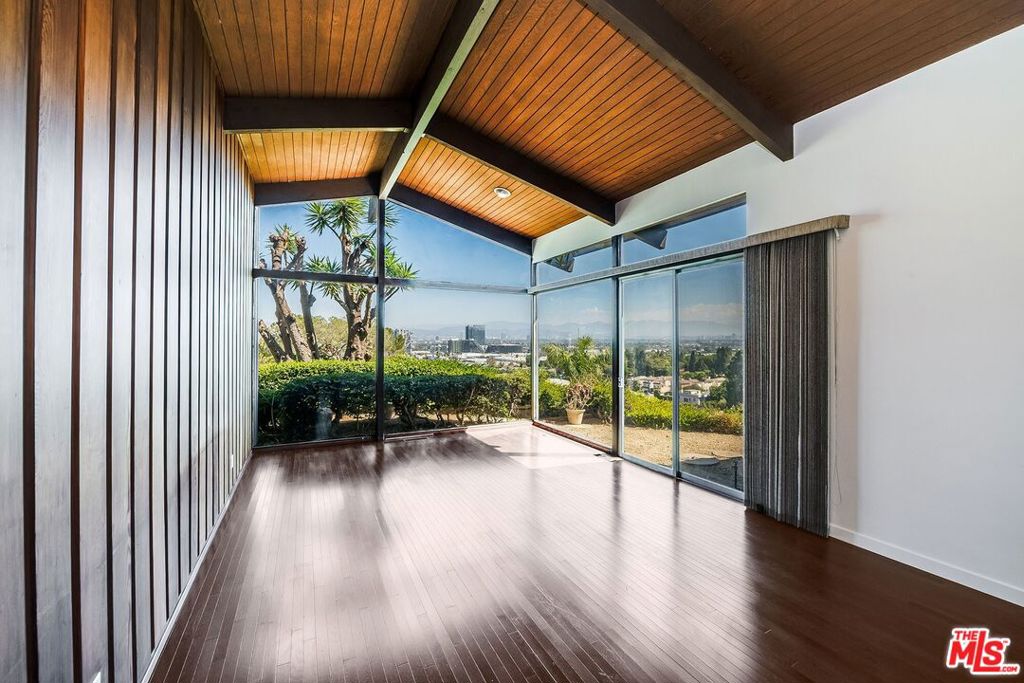 Craving jetliner views, retro charm, and your own private escape above the city? Welcome to this spectacular mid-century home in Culver City's coveted Blair Hills, where every room feels like a front-row seat to LA's greatest show. From the shimmering lights of Downtown to the hills of Hollywood, the vistas here are pure magic. Set at the end of a long driveway, the home sits perched on its own knoll, offering privacy, tranquility, and major cool factor. The living room has soaring vaulted ceilings and walls of glass that flood the space with light. A separate family room with a wood-burning fireplace opens out to the pool -- perfect for effortless indoor-outdoor living and late-night hangouts under the stars. There are three bedrooms, including a great primary suite and a large, flexible secondary bedroom (ideal for kids, a playroom, or a creative studio). The pool and yard make entertaining a no-brainer, while the open flow keeps the vibe relaxed yet elevated. When it's time to leave your retreat, you're less than a block from Blair Hills Park, moments from the trails at Stoneview Nature Center, and just across the bridge to Kenneth Hahn Park. Mid-century architecture, cinematic views, and a location that's both private and connected, this is LA living at its coolest.