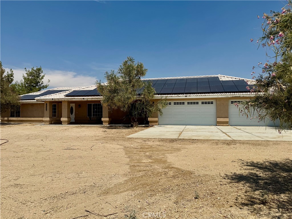 Welcome to wide-open living in the High Desert. Set on roughly 1.83 private, fully fenced acres with desert and mountain vistas, this 2007 single-level home blends elbow room with everyday comfort. Inside, an airy, high-ceiling layout centers around a welcoming family room fireplace, flowing to a spacious kitchen and dining area ideal for easy entertaining and relaxed daily living. Four bedrooms and three full baths, all on one level, offer flexibility for guests, multigenerational living, or a dedicated office. A four-car attached garage and long driveway deliver the parking and storage you’re looking for. Practical upgrades and features include central heat and A/C, dedicated indoor laundry, laminate flooring, and chain-link perimeter fencing. The expansive parcel gives you room to spread out. Bring your RV, trailers, and toys, set up animal enclosures, or plan a future workshop. Buyers to verify zoning and any desired improvements. With no HOA and a location moments from local amenities, schools in Snowline Joint Unified, and major area connectors, you get the rural lifestyle without sacrificing convenience. If you’ve been searching for space, privacy, and a move-in friendly home that can grow with your plans, 5330 Goss Rd is the one!