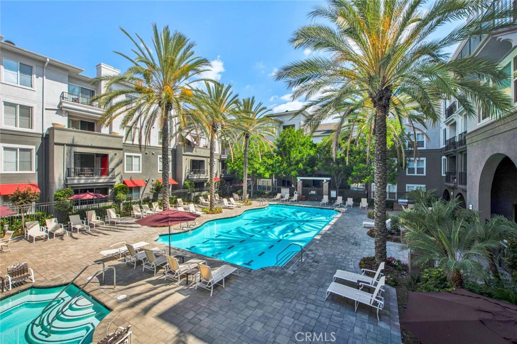 Welcome to the Stadium Lofts, an unparalleled blend of comfort, luxury, and convenience. The community offers a range of resort-style amenities, including a heated pool and spa, a fitness center with Peloton room, a game room, and meticulously landscaped courtyards equipped with barbecue areas. This residence features two bedrooms and two bathrooms, each strategically positioned for privacy; one of the bedrooms serves as the primary suite. The interior has black granite countertops, modern cabinetry, stainless steel appliances, and an in-unit washer and dryer. This specific unit also includes a separate storage unit within the building and provides two assigned parking spaces, numbered #3018 and #5028. The residence is ready for immediate occupation. Stadium Lofts is ideally situated in Anaheim's Platinum Triangle, within walking distance of Gardenwalk, various shopping and dining establishments, Angel Stadium, Honda Center, Disneyland, and the Block at Orange. Furthermore, the location affords convenient access to the 5, 57, 22, and 55 freeways, placing you in proximity to all the attractions Anaheim offers. We invite you to experience 1801 East Katella and all the exceptional opportunities in this vibrant area.