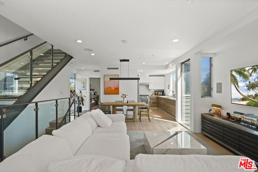 Beautiful architectural home just one block from Abbot Kinney's best restaurants and boutiques and a short stroll to the beach. Bathed in natural light, this 3-bed/3-bath, 1,844 SF residence showcases top-tier finishes and a thoughtful, indooroutdoor floor plan. The entry level features a private, attached 2-car garage and a flexible media room/home office (third bedroom option) with an adjacent bath and access to a tranquil ground-floor patio. A glass-paneled staircase leads to the open second-floor living and dining area, seamlessly connected to a chef's kitchen appointed with Viking appliances, sleek cabinetry, and generous prep/storage space. A bright bedroom and full bath complete this level. Upstairs, the primary suite enjoys its own deck entrance, a large closet with built-ins, and a spacious spa bath with separate soaking tub and dual vanity. Outdoor areas on every level, patio, balcony, and upper deck, expand your living space and make everyday life and entertaining effortless. Prime Venice location near parks, cafes, galleries, and the sand-modern coastal living at its best. Offered unfurnished, with an option to lease fully furnished at $14,800/month.