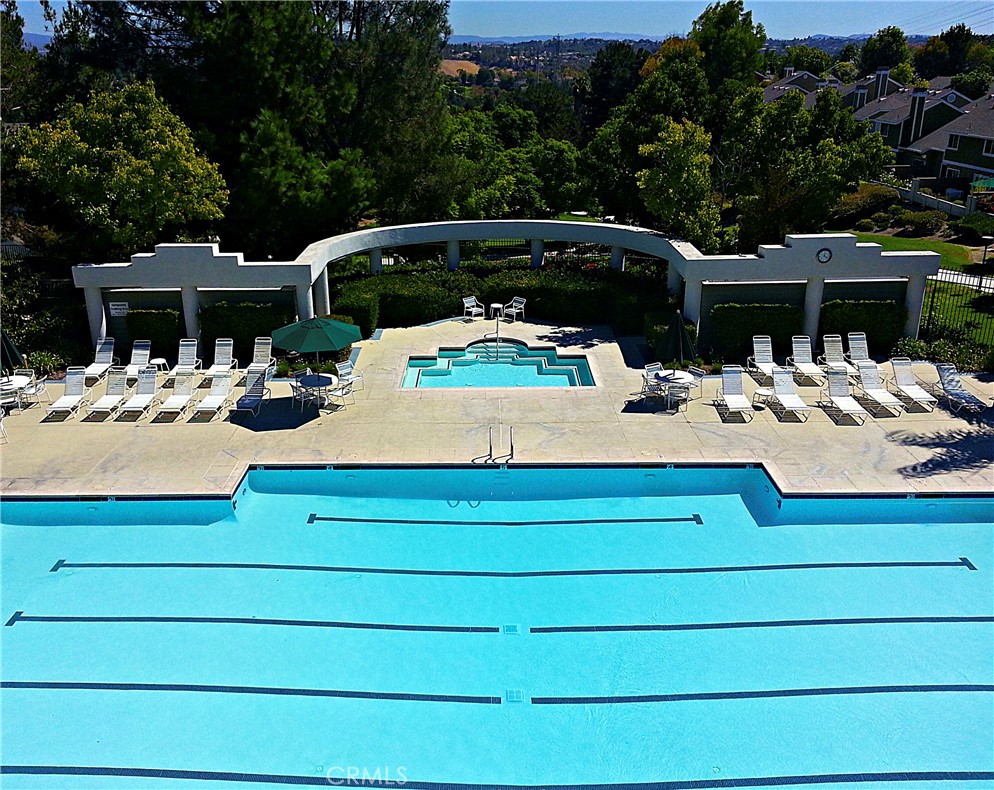 Rare opportunity to own this Glenwood Terrace 4- Bedroom home with Loft and exceptional community amenities! Welcome to this 4 -bedroom, 3- bathroom home boasting 2109 sq ft of well-designed living space. With a versatile floor plan that includes a downstairs bedroom and full bathroom , this home offers flexibility and comfort for guests or multigenerational living. The bright and airy interior features formal living room and formal dining room, and a kitchen that opens to the cozy family room with wood burning fireplace. Enjoy modern touches , recessed lighting, ceiling fans, energy -efficient solar panels and newer windows both style and efficiency. Three elegant French doors open to the spacious private backyard-perfect for entertaining or relaxing outdoors. Upstairs, you'll find three additional bedrooms, including a generous primary suite , along with two full bathrooms and a spacious loft used for an office, craft room, gym or kids play room. Located in a highly desirable community loaded with Resort Style amenities: lap pool, jacuzzi, kids' pool, clubhouse, gym, tennis courts, play area, BBQ area, and a beautifully maintained greenbelt. Conveniently close to top-rated schools, shopping, dining, toll roads, golf courses, and just a short drive to iconic Laguna Beach! Don't miss this opportunity to own a home that blends comfort , style, and unbeatable location!!!