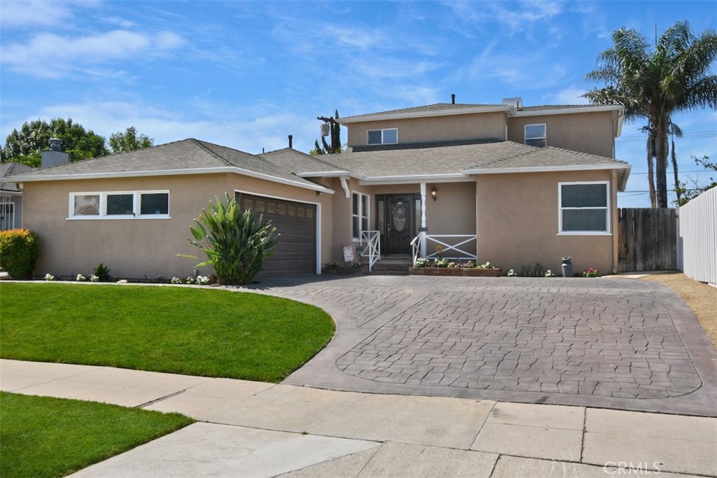 This beautifully expanded Reseda home offers 4 spacious bedrooms, 2.5 bathrooms, and 2,244 square feet of comfortable living space. The main level features three bedrooms and one and a half baths, accented by newer light-toned hardwood flooring. Enjoy the inviting step-down living room with a cozy fireplace, and a generous kitchen with a breakfast bar that opens to the dining area. The dining room is enhanced with custom built-in shelving and cabinetry, providing ample space for storage and display. Upstairs, you’ll find a versatile office or loft area along with the private primary suite, which boasts a walk-in closet and an expansive bathroom with double sinks and a relaxing spa tub. Start your mornings with coffee on the private balcony off the primary bedroom while enjoying the tranquil sounds of the backyard fountain. The manicured backyard is ideal for entertaining, offering the perfect balance of patio and green space, surrounded by a tall wood fence for added privacy and no neighbors directly behind. Take advantage of the nearby lighted Los Angeles Riverwalk, with miles of biking and walking paths, plus convenient access to local shops and restaurants. Additional highlights include a spacious stamped concrete driveway, recessed lighting, newer windows, elegant crown molding, two HVAC systems, abundant natural light, and plenty of storage throughout.