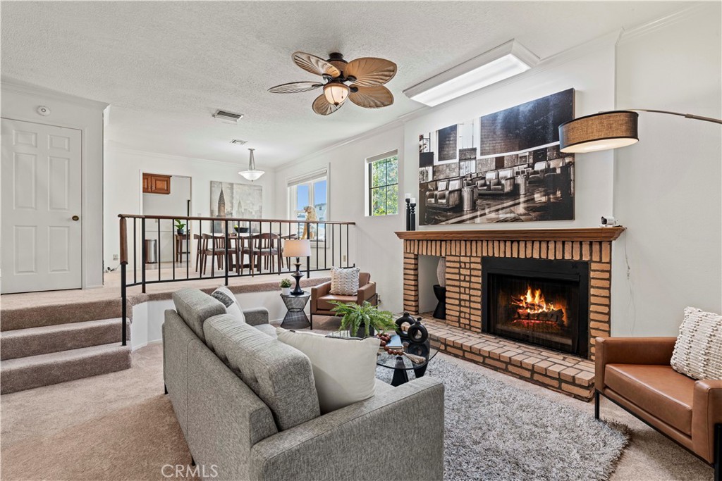 Welcome to a truly stunning and rare find in the heart of Studio City: a sophisticated & upgraded tri-level townhome with a private rooftop penthouse oasis. Tucked away on the quiet, tree-lined Bloomfield Street, with a private gated entrance and a serene walkway & garden this hidden gem shares ground with only four townhouse units. This immaculate, move-in-ready home, is designed to impress. This unique “turn-key” sanctuary features comprehensive smart home automation, including automated sensor lighting, a Ring doorbell, Nest thermostat, and Lutron lighting. Upgrades like fresh paint, new carpeting, new flush ceiling lights, and beautiful crown molding are found throughout. With upgraded electrical and plumbing, plus a newer, economical HVAC system, this home ensures comfort and low utility costs. The home includes a rare low HOA fee of $300, which uniquely includes gardening, water, trash, exterior lighting, and building insurance. Step inside to a spacious, light-filled living area with soaring ceilings, a cozy wood-burning/gas fireplace, and an inviting large bay window with wide seating — the perfect spot for reading or relaxing with your canine companion. The formal dining area flows seamlessly into a beautifully remodeled kitchen featuring elegant cherry wood cabinetry, gleaming granite countertops, stainless steel appliances, under cabinet lighting and a built-in ceiling sprinkler system for safety. The expansive primary master bedroom suite boasts dramatic 12-foot ceilings, a spacious walk-in closet, a custom vanity, a large tub/shower combo, and its own private shaded balcony under the trees. A second bedroom also features its own private en-suite bath. The home's pet-friendly, no-maintenance backyard features artificial turf and a convenient pet door for easy, private and safe access. The crown jewel of this home is the private rooftop penthouse and terrace. Ascend a sunlit staircase—illuminated by a stunning skylight and adorned with a one-of-a-kind mural painted by the home’s owner, an accomplished filmmaker. Discover a fully enclosed sunroom with its own heating, AC, and a solar fan—ideal for a bright home office, yoga studio, or entertainment lounge in the sky. This spectacular retreat offers panoramic 360-degree views of Studio City from an expansive deck with intricate stamped concrete. Also included is a 15' x 8' storage space. Located within walking distance of The Shops at Sportsman's Lodge, Harvard Westlake, and the major studios.