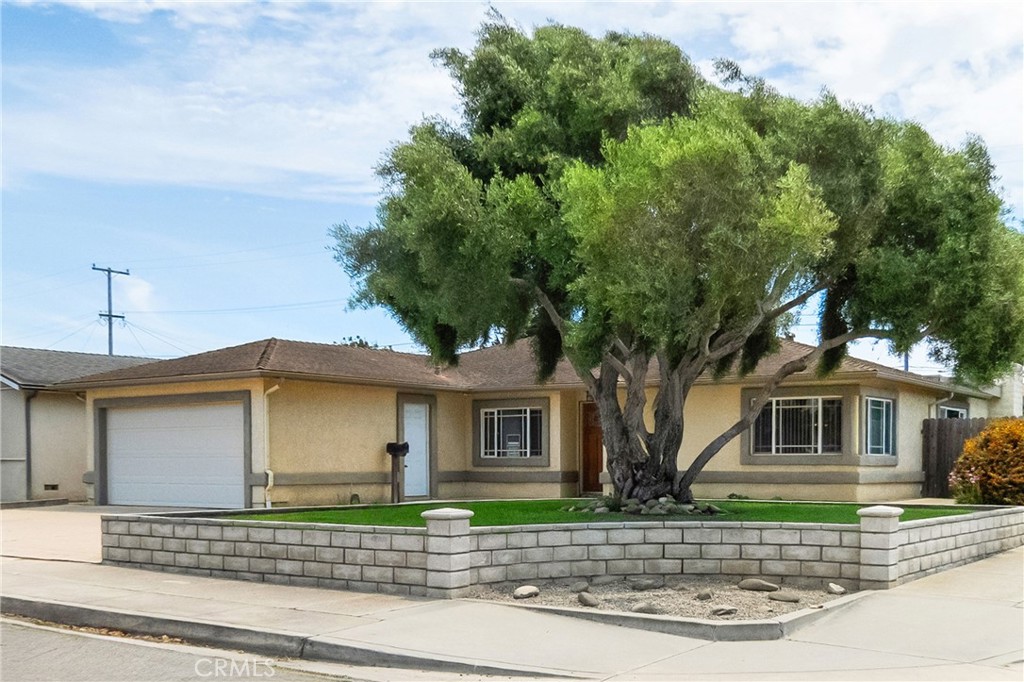 Super clean, move in ready & spacious 4 bedroom, 2 bath, approx. 1,748 sq ft home situated on a beautifully landscaped corner lot! Features include updated kitchen with newer cabinets, Corian counters, island with pendant lights, new stove, newer microwave & large dining area; updated bathrooms with new vanities & lighting, nice tile in tub/shower surround & floors; formal living room; separate family room with fireplace & slider to back patio perfect for entertaining; interior laundry room; tile & beautiful new luxury vinyl plank flooring with wide baseboards throughout; bedrooms all have overhead lighting; updated panel doors, lighting & fixtures throughout; new interior paint; newer dual pane windows & new blinds; 2 car attached garage; nice backyard with open patio, producing lemon tree & back gate with alley access. Hurry before it's gone!