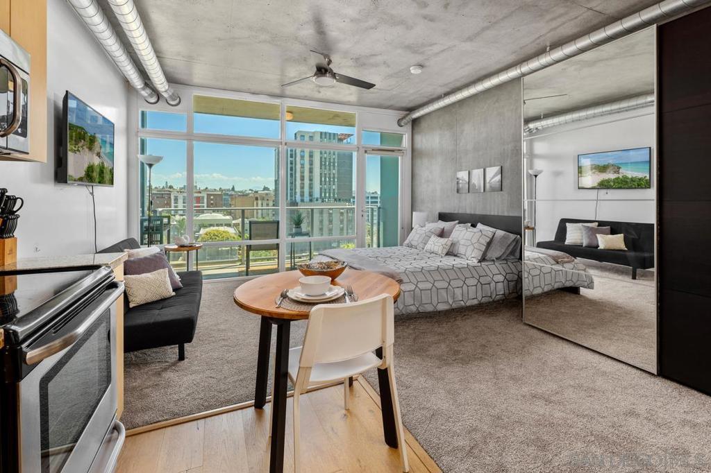 Modern living meets the energy of Downtown San Diego! This stylish Smart Corner condo offers a bright, open floor plan with floor-to-ceiling windows and a private balcony — perfect for soaking in the city views and vibrant atmosphere below. Its functional layout is ideal for both relaxing and entertaining. The kitchen flows seamlessly into the living area, while natural light fills the space. Building amenities include a rooftop deck with panoramic city and bay views, a BBQ and lounge area, spa, and fitness center — all designed to elevate your lifestyle. Walk to the Gaslamp Quarter for dining and nightlife, catch a Padres game at Petco Park, or explore the trendy cafés and breweries in East Village. Local favorites like Café 21, The Mission, and Knotty Barrel are just blocks away. For a change of pace, head to Balboa Park for museums, gardens, and trails, or enjoy a waterfront stroll at Seaport Village. With the trolley stop right outside your building, the entire city is at your doorstep. This is downtown living at its best — convenient, connected, and full of possibilities.