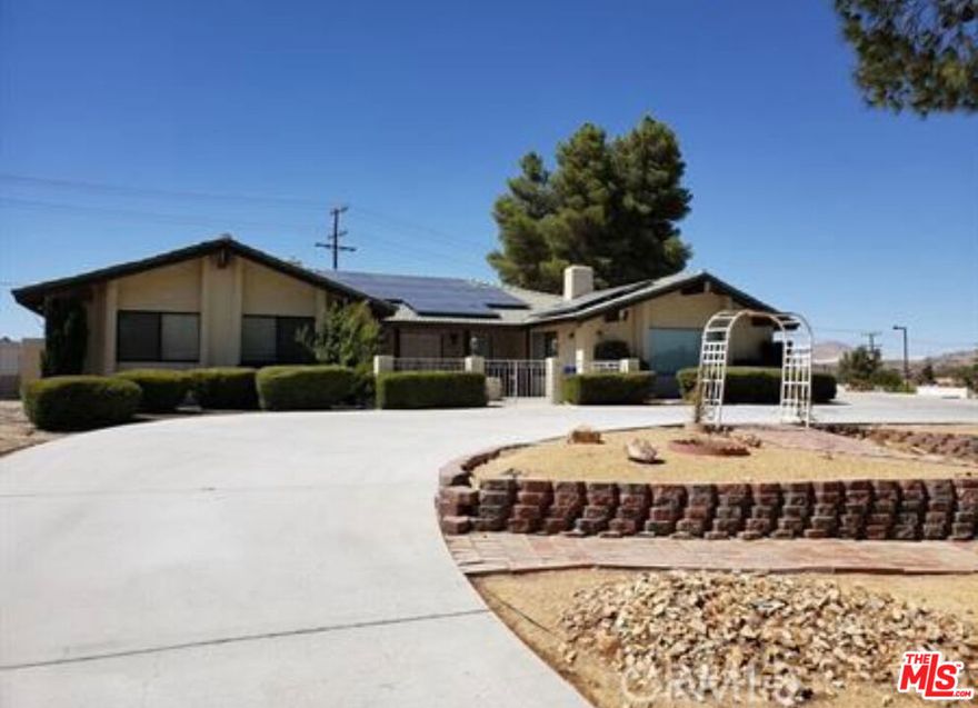 This Beautifully Upgraded Solar Powered Apple Valley Home Offers 5 Bedrooms, 3 Baths with a Formal Living Room with a Fireplace, a Family Room with a Fireplace and a Large Den!!!  It offers a formal dining room, full laundry room, solar lease (no additional monthly payment), a Large Swimming Pool that has been recently plastered.  In addition it sits on a  1 acre lot!!!  Ideal for RV/Boat Parking, storage and much more!!!
