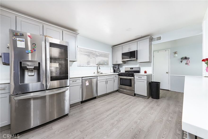Step into this stunningly renovated 3-bedroom, 2-bathroom home, boasting over 1,300 square feet of style and comfort. This home has been thoughtfully upgraded with a newly designed open-concept kitchen, featuring fresh NEW cabinets, sleek NEW counters, and a brand-NEW sink & garbage disposal. The living areas showcase smooth walls, recently, added recess lighting, NEW flooring, and fresh paint throughout, creating a clean and inviting atmosphere. The kitchen, laundry room, and pantry have all been reimagined for modern living, while NEW water heater and mini split system provide year-round comfort. A beautiful Wood-burning Fireplace located in the living room sure to keep your family cozy and warm during winter family movie nights, enjoy a spacious backyard, perfect for entertaining, plus a dog run for pet lovers. 2 car garage was being used as another bedroom.The large driveway offers plenty of space for parking. With a little extra love and creativity, this home has potential to be your perfect escape. Located conveniently close to the freeway, mall, hospital, restaurants, multiple parks and great school districts. This home is ready for the next family to make it their own!