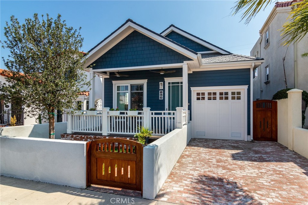 Welcome to Belmont Shore! 162 Pomona Ave stands out as one of the most charming homes in the Shore, fully remodeled from the ground up with no detail or expense spared. Every corner of this residence exudes warmth and style, blending timeless character with modern upgrades. Step inside to find wide-plank oak laminate and tile flooring, soaring 10-foot ceilings, recessed lighting, ceiling fans, window coverings, and full HVAC throughout. The open-concept living room impresses with 18-foot vaulted ceilings and sliders that flow seamlessly to a spacious Hardibacker deck overlooking the beautifully landscaped front yard—complete with a craftsman Koa wood gate and lush grass area, perfect for kids and pets. The chef’s kitchen is a true showstopper, featuring high-end stainless steel and custom appliances, a wine cooler, farm sink, quartz countertops, interior-lit cabinetry, and an island with bar seating. Just off the kitchen, a dedicated dining room opens to the side patio, creating an effortless indoor-outdoor experience.The private primary suite offers a custom California Closet system and a spa-like ensuite with an oversized walk-in shower, rain shower head, built-in bench, and stone-topped vanity. Large sliders extend to the serene back brick patio—an inviting spot to enjoy your morning coffee. A second bedroom with custom closet, full guest bath, and stackable laundry closet complete the interior. Additional highlights include a 1-car attached garage with built-in storage, tankless water heater, EV-ready wiring, and potential for a 250 sq. ft. addition above the garage. Parking for 2 more cars in the driveway adds convenience. Plus, extra 300 sq. ft. expansion potential above the second bedroom offers room to grow. All this just one block from the beach and bay, and a short stroll to Belmont Shore’s shops and restaurants. This home is a true coastal gem!