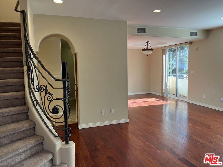 This elegant three-story townhouse is situated in Valley Village, south of Riverside Dr. on Studio City border. Located on a quiet, tree-lined street, with easy access to the 101, 134 & 405 freeways, this unit features 3 bedrooms and 2 1/2 baths, spacious living spaces, light and bright, upper level with skylight, a porch on the main floor, private balcony and private roof deck terrace off the primary bedroom. Laundry units are on the second floor. Kitchen is fully-equipped with stainless steel appliances, custom cabinetry and granite countertops. Living area also features gas fireplace. Two-car private attached garage. Guest parking in fully gated property.