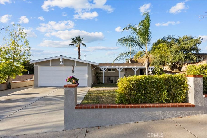 CHARMING SINGLE STORY HOME ON THE HILL IN UPPER NORTH OAKS... Don't miss this beautiful home in Canyon Country on a quiet mature tree lined street.  Set back off the street w/ a great sized (almost 8K sq ft) lot, this home features brand new doors and windows throughout.  New dual pane, low E windows will keep your Edison bills down in the summer.  Newer wood like floors wrap through the house w/ carpet in the bedrooms.  The galley-like kitchen opens up to your family room, with a slider that leads you to your own huge private backyard.  Both bathrooms have recently been remodeled w/ modern tile, soap box, and newer upgraded fixtures.  One of the bedrooms has a completely separate entrance that doesn't go through the main house. There are covered patios in both the from and the rear yards, with tons of room to relax and watch the kids run around and play.  This home also offers a 2 car garage.  This property is located in the heart of Canyon Country, walking distance to an elementary school, and a JR High School.  High School is a mile and a half away, and there is plenty of dining and shopping nearby.  WITH NO HOA, and NO MELLO ROOS this baby won't last!  This home can be shown 7 days a week, so call today for your private showing.
