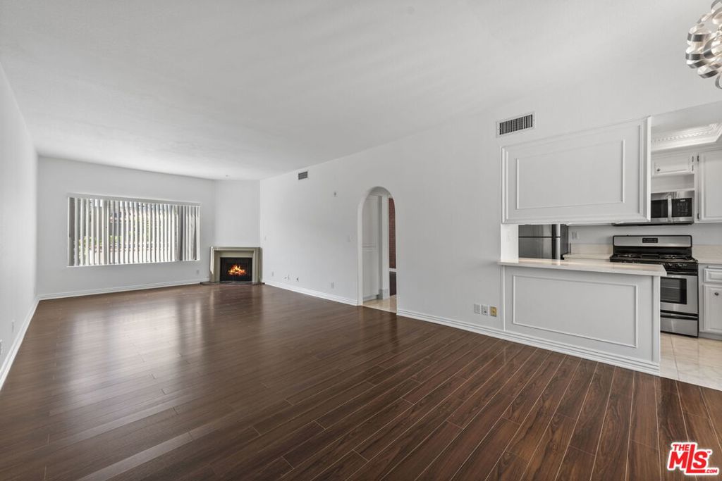 Spacious and updated one bedroom, one bath unit in a secure building with lobby entry & elevator access. Expansive living room & dining area with fireplace. Modern kitchen with new stainless steel appliances & granite countertops. Wood floors throughout. Ample closets. One parking space gated. Community washer & dryer. Tenant to carry renter's insurance. Tenant pays utilities. By appointment.