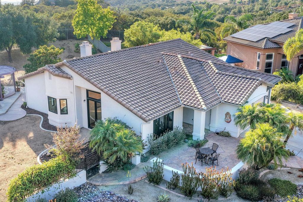 Nestled in a quiet end of cul-de-sac location in the highly coveted Mount Woodson gated golf community, this stunning single-level home sits on just shy of 1/2 acre. Features include remodeled bathrooms, updated lighting, new dual-pane windows, fresh interior/exterior paint, drought tolerant landscaping, owned solar - just about 3 years old, and both Tesla and EV charger outlets. This gorgeous neighborhood has trails, low HOA fees & offers the feeling of being away while you are still close to everything! Welcome to the highly sought-after Mount Woodson gated golf community. This beautiful neighborhood offers the feeling of being away while still being close to everything! There is plenty of open space, beautiful scenery, walking trails and a fantastic view of the famous potato chip rock right out your back door. This stunning single-level home offers a huge lot with plenty of possibilities! Step inside to an open and airy floor plan filled with natural light. Features include recently remodeled bathrooms, new dual-pane windows, fresh interior and exterior paint, and beautifully updated landscaping that offers incredible curb appeal. Enjoy peace of mind and energy savings with fully owned solar, installed just three years ago. The 3-car garage provides ample space for vehicles, storage, or a workshop, and the expansive backyard offers limitless possibilities—whether you're dreaming of a pool, a garden, or an outdoor entertaining area. With low HOA fees and a serene, private setting, this home is the perfect blend of comfort, space, and location. Don’t miss the opportunity to make it yours!