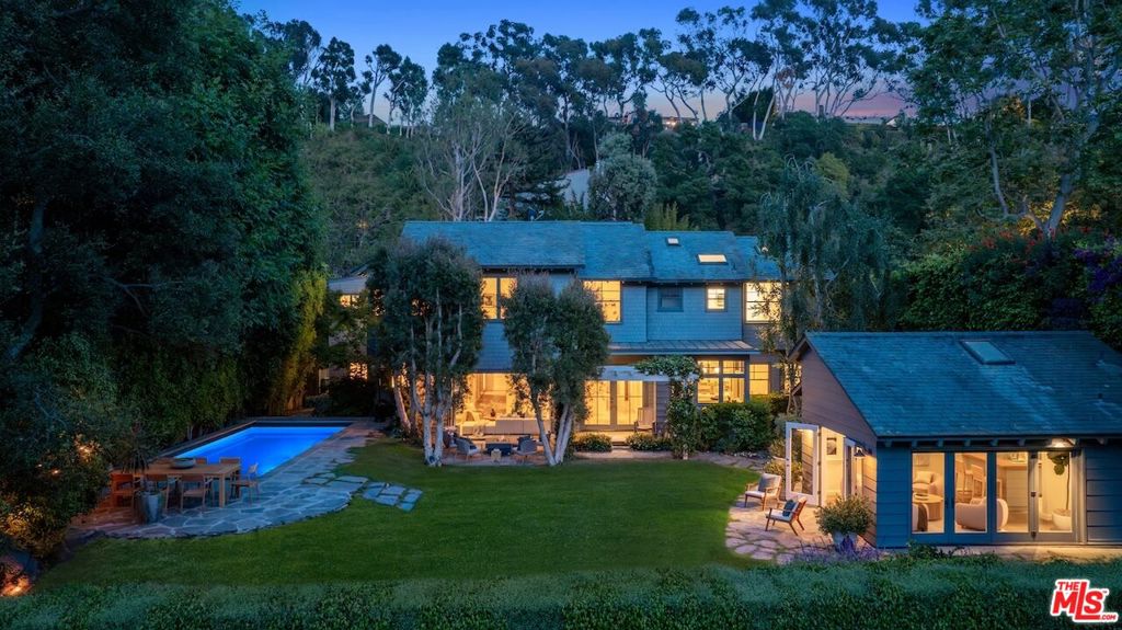 Welcome to this quintessential California Craftsman, an architectural jewel nestled in the heart of prime Rustic Canyon. Tucked away at the end of a quiet cul-de-sac and surrounded by mature trees, this warm and inviting estate captures the essence of the Arts and Crafts tradition while offering the luxury and scale of modern California living. Beyond the gates, the home unfolds across a sprawling, sun-drenched lot, revealing rich dark-stained shingles, vaulted wood-beamed ceilings, and artisan stone and wood floors throughout. The grand open-concept living and dining space is anchored by a striking river rock fireplace, creating a serene setting for elevated everyday living and effortless entertaining. A remodeled chef's kitchen, casual dining area, and family room seamlessly flow to the outdoors through French doors, unveiling expansive stone patios, lush gardens, a swimmer's pool, and a generous lawn. A separate pool house with half bath and a charming detached guest room enhances the property's lifestyle appeal. With 5 spacious bedrooms and 5.5 baths, the residence is designed for flexible luxury. The primary suite is a sanctuary unto itself, featuring dual walk-in closets, a newly reimagined spa-like bath, and a peaceful sitting area. Additional highlights include a dedicated office or den, a large upstairs playroom with terrace, and a three-car garage. Private and secluded, this residence evokes the tranquility of a retreat far from the city, yet remains just moments from Rustic Canyon Park, the beach, and the best of the Westside. A rare and timeless offering in one of LA's most coveted enclaves.