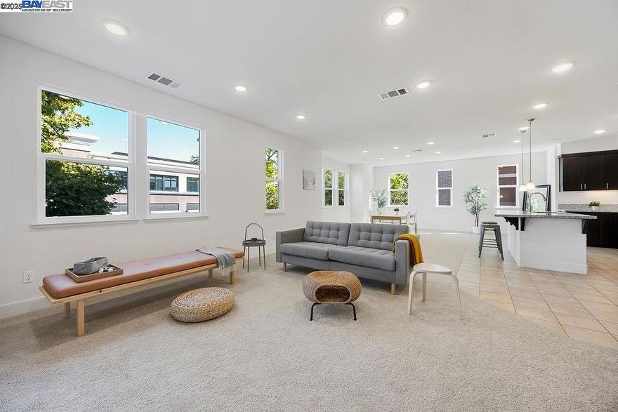 Discover comfortable modern living in the heart of Alameda Landing— a tri-level townhome-style condo that effortlessly blends sophisticated design, generous space, and everyday convenience. Lovingly maintained and move-in ready, this 3-bedroom, 2.5-bath residence spans 2,303 sq. ft. of bright, contemporary living just minutes from waterfront trails, shopping, and dining.  Enter through a welcoming first floor with storage closet and direct access to a spacious two-car garage, before ascending to the open-concept main level - where sunlight illuminates an open-concept Great Room perfect for effortless entertaining. The chef-inspired kitchen shines with stainless steel appliances, sleek granite counters, an eat-in island, and abundant cabinetry, while the adjacent dining area and private balcony create an easy flow for relaxing or entertaining.   Outside your door, life at Alameda Landing means effortless access to everything—Target, Safeway and popular eateries are just minutes away. Enjoy waterfront trails, community parks, and the local business favorites of Webster Street. Commuting is effortless with easy access to the Alameda Ferry, HWY 880, and Oakland Airport.