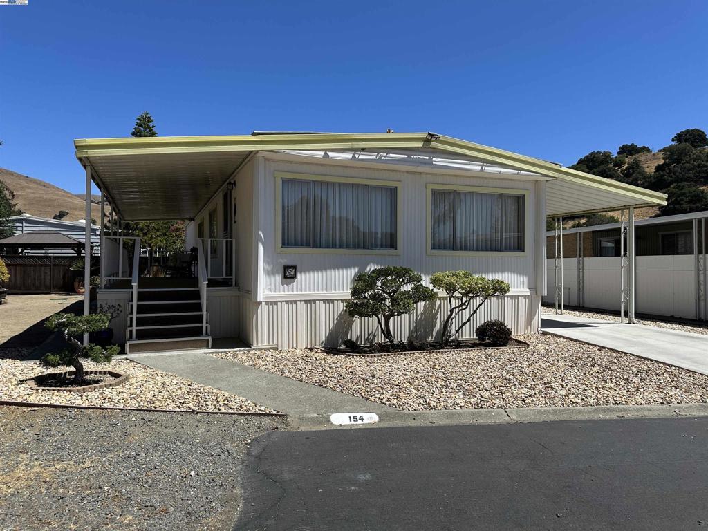 Affordable 2 bedroom, 2 Bathroom Mobile Home in Scenic Niles Canyon – A 55+ Adult Community Nestled in the hills of Fremont, this well cared for home in Niles Canyon Mobile Estates offers serene living with stunning views. Light interior walls, updated kitchen w/ refrigerator that stays; Central heating and air conditioning; Interior washer and dryer that stay; Large covered side porch looks onto spacious yard; New cement driveway w/covered storage shed. Enjoy the community’s impressive amenities: a year-round heated pool, hot tub, sauna, pool room, library, TV room, and a fully equipped kitchen in the clubhouse for events and gatherings. All this just minutes from charming downtown Niles – don’t miss out on this perfect blend of comfort, convenience, and community! Fireplaces: NO