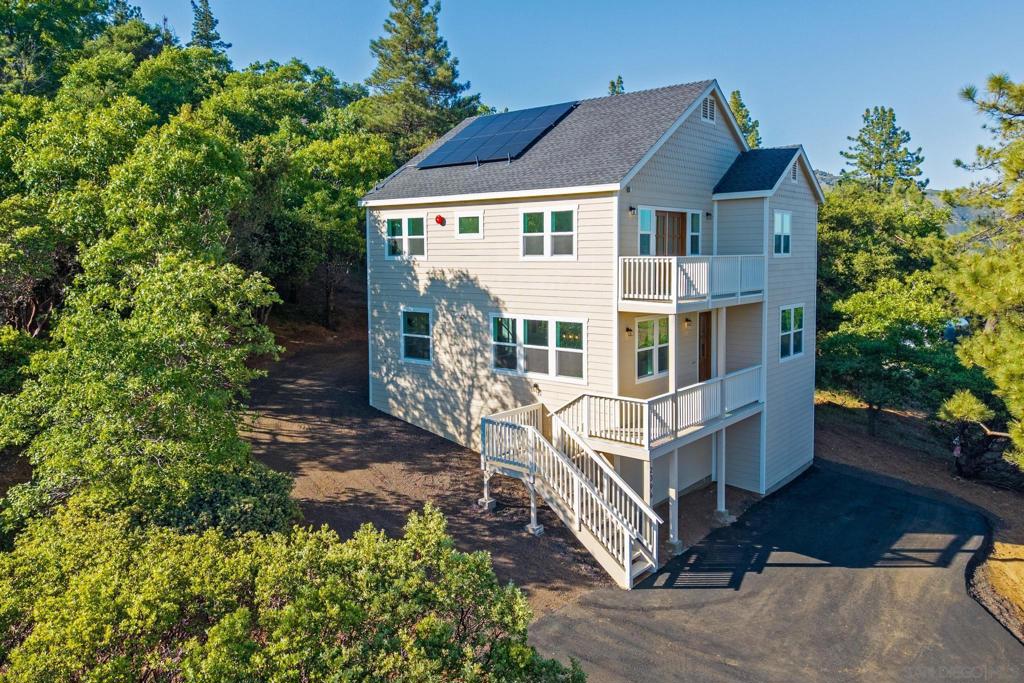 HIGHLY MOTIVATED SELLER! Take advantage of this incredible opportunity - seller is willing to offer a CREDIT TOWARDS BUYER'S CLOSING COSTS OR A RATE BUY-DOWN, helping reduce your monthly mortgage payment. NEW CONSTRUCTION with Mountain Views – Walk to Main Street Julian! Don’t miss this brand new, never-lived-in 3 bed, 2.5 bath home on 1.25 acres in the heart of Julian, CA! With approximately 2,020 sq ft of living space, this thoughtfully designed home combines modern finishes with breathtaking views from almost every room. The open-concept layout is filled with natural light and features a gorgeous kitchen with an oversized island, quartz countertops, walk-in pantry, and all-new stainless steel appliances — perfect for entertaining. The spacious living room opens to a private balcony where you can relax and take in sweeping mountain views or stargaze on clear nights. Upstairs, all three bedrooms are generously sized, including a luxurious primary suite that feels like a private retreat. Enjoy your own balcony, mountain views, walk-in closet with barn door, dual vanities, soaking tub, and a large walk-in shower. Tucked away in the trees yet just a short walk to Main Street shops, restaurants, and cafes, this home offers the best of both privacy and convenience. Solar installed. Plenty of space to create your dream outdoor area. Whether you're looking for a full-time residence, weekend getaway, or investment property, this home has it all. Julian is a charming historic town nestled in the Cuyamaca Mountains, about an hour east of San Diego. Known for its small-town charm, gold rush history, and famous apple orchards, Julian is a popular getaway for those looking to enjoy fresh mountain air, scenic landscapes, and a slower pace of life. Real estate in Julian ranges from historic cabins to modern mountain retreats, making it an ideal location for those looking for a peaceful, nature-filled lifestyle with easy access to San Diego.