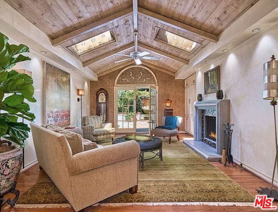 This 2BD/2BA ~2,000 sqft traditional home is located in the highly-desirable neighborhood of Beverlywood. Step through a double-door into a foyer which leads to an impressive living room with dramatic vaulted ceilings, skylights, recessed lighting, French doors, and gleaming hardwood floors. Venetian plaster lines most walls and allows light to reflect from one room to another. A spacious kitchen showcases stainless-steel appliances, custom-made cabinets, and granite counter tops. A dining area is adjacent to the kitchen, as is a laundry room. The master bedroom has a travertine fireplace, floor-to-ceiling windows, and a walk-in-closet. Master bath has dual sinks, spa tub, water closet, and an oversized step in shower. Another large bedroom (with access to a bathroom) has French doors to the backyard. The backyard area is a "secret garden"-like setting with lush, colorful vegetation and a soothing fountain.