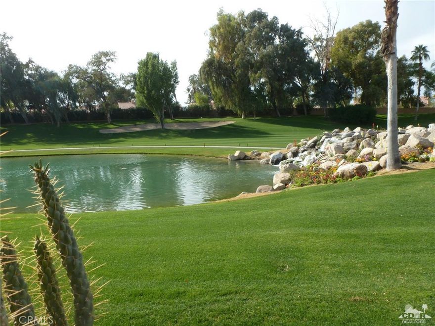 This gorgeous Riviera model with attached garage is located in a premium spot with patio facing the magnificent waterfall and lake on the 5th fairway and green! The water fall is alive with vibrantly colored flowers and attractive boulders. This two-story model with vaulted ceiling has a master suite upstairs with two walk in closets and a den/study area. The home comes fully furnished and master has a two-month-old sleep-number king bed. There is also a master bedroom downstairs with en suite bathroom. A third room currently used as a den could be a third bedroom. Beautifully mirrored walls reflect light and beauty in this home. A spacious open plan has the kitchen open to all downstairs living area. A fireplace twinkles and reflects the mirror when lit. The perfect space for entertaining which expands when you open the large sliders to the patio and view. HOA fee $505 includes outside maintenance and roof, insurance, and many other. Too many extras to list here.