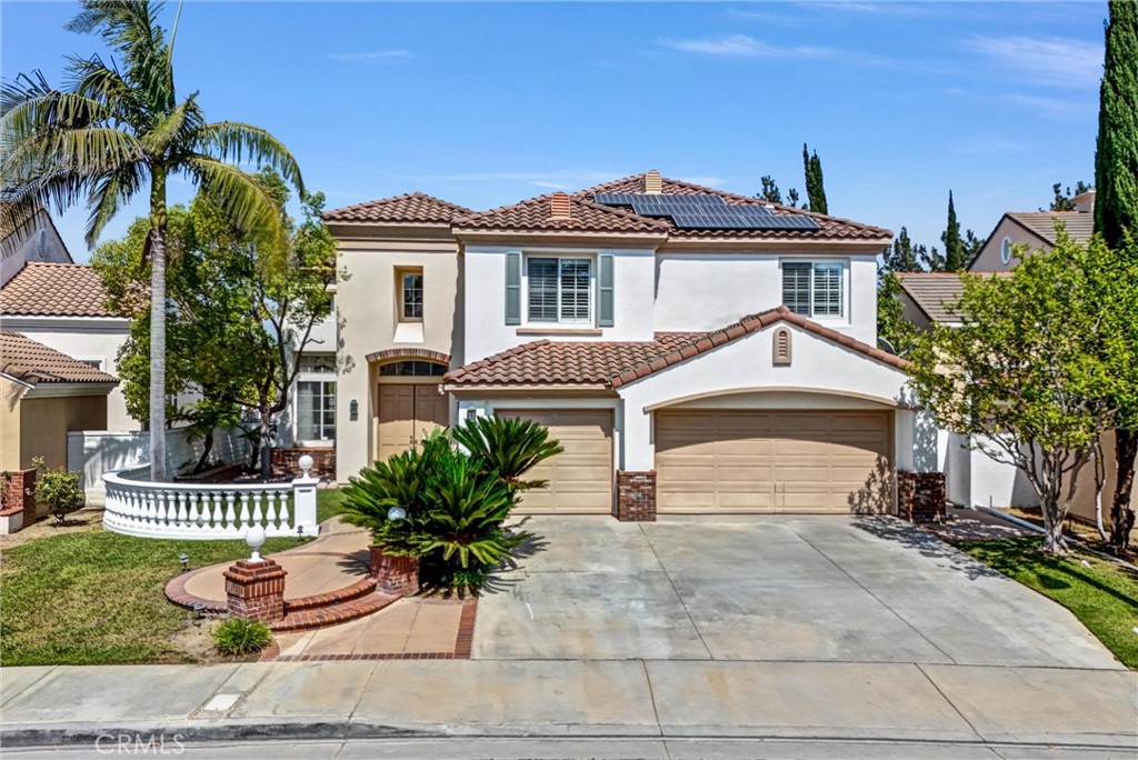 This exquisitely remodeled home is located in the prestigious Ridgemoor gated community with 24-hour guard security. Nestled in a serene neighborhood, this romantic residence offers a perfect blend of luxury, comfort, and elegance. As you enter the double door grand foyer, you're greeted by soaring ceilings and an abundance of natural light that flows through the open-concept formal living and dining rooms, highlighted by a dazzling crystal chandelier and an elegant spiral staircase. The gourmet kitchen is a chef’s dream, featuring a large center island, exquisite granite countertops, premium appliances including a Viking stove, a range hood, double ovens, a dish washer, and a microwave. Refaced cabinets with new drawers and doors provide a fresh, modern touch. The cozy family room showcases a classic stone fireplace and marble flooring, perfect for relaxed gatherings. The main floor also features a suite with a full bath, a powder room, a laundry room, a small storage room, an additional spacious storage room, equipped with wood shutter windows overlooking the beautiful backyard. Upstairs, the expansive primary suite offers stunning panoramic views of city lights and mountains through large picture windows. It includes a spacious walk-in closet and a newly upgraded bathroom with newly refaced cabinets, new countertops, dual sinks, lighting, a soaking tub, and a walk-in shower, all designed for both comfort and grandeur. You’ll find 3 other generously sized bedrooms and 2 upgraded bathrooms. Additional stunning features include newly painted walls and ceilings throughout the interior and even the garage, brand new flooring, fully paid-off solar panel system, brand new water heater, new countertops, sinks, mirrors, and lightings, six sparkling crystal chandeliers, wood shutters, professionally landscaped front and backyards with a sparkling swimming pool and spa, showcasing the latest in design and craftsmanship. Enjoy a prime location just minutes from top-rated schools, library, shopping centers, markets, banks, freeways, and a wide array of dining options. This house is much more than just a gracious home, offering both unparalleled luxurious living and a perfect setting for prosperity and success. A must-see in Rowland Heights' most coveted community.