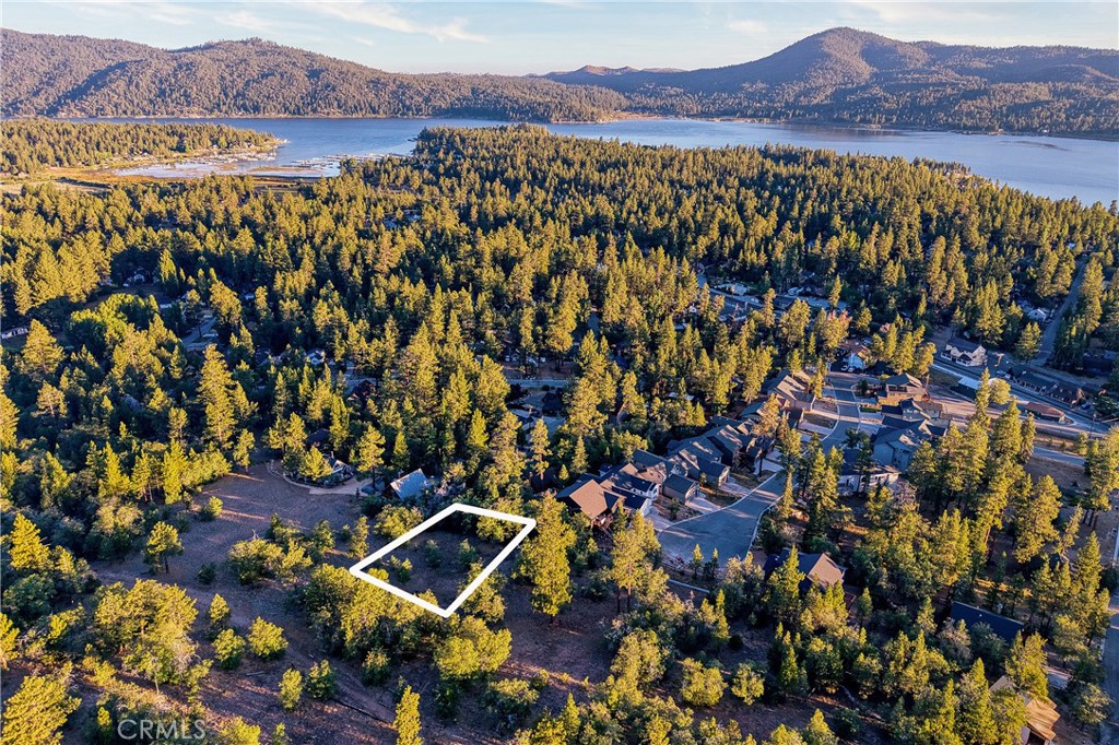 Call of the Wild. Rare opportunity to own a surveyed quarter-acre lot backing directly to National Forest in one of Big Bear’s most sought-after settings. Tucked at the end of a quiet cul-de-sac, this property offers true privacy, sweeping mountain views, a seasonal stream, and unfiltered access to miles of trails—right out your back door.
It’s the kind of spot that feels like a step back in time: quiet mornings, starry nights, and that peaceful stillness only the forest can offer. Yet you’re still within walking distance to the Village, lake, Alpine Slide, and more.
Whether you're dreaming of a weekend cabin or a simple mountain retreat, this lot offers a rare blend of seclusion and convenience. Lots like this don’t last—especially ones with this much character and connection to nature.