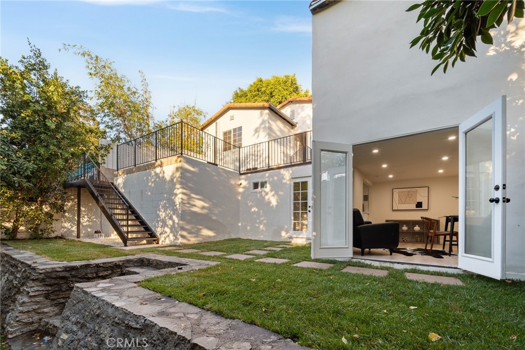 Welcome to this unique Echo Park retreat with Spanish-style accents. As you arrive, you’re greeted by a charming front patio that leads into the main home 915 sqft. Inside, hardwood floors throughout, skylights to highlight its charm, and top of the line Café Signature appliances that creates a gorgeous kitchen feel. The home offers two great size bedrooms, including one with a spacious walk-in closet and another with beautiful views. The bathroom is thoughtfully designed with Spanish-style tile and a skylight, adding brightness and character.
Step outside to a welcoming deck overlooking a grassy play/bbq area. On this level, the garage has been transformed into a serene yoga room. Heading down the stairs, you’ll discover a second backyard level, along with a versatile bonus room/office complete with its own bathroom.
Recent upgrades include a completely retrofitted foundation done to city standards, providing peace of mind for the next owner, as well as a brand-new roof. This home blends timeless Spanish charm with modern updates—perfect for those seeking character, functionality, and comfort in the heart of Echo Park. Within walking distance to MacArthur Park, the Metro station, the historic Alvarado Terrace district, the iconic Westlake Theatre, and the famous Langer’s Deli, this home offers the best of LA right at your doorstep.