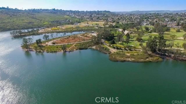 This is a spectacular opportunity to own a lake-view condo that is a stone's throw from some of the best walking trails in La Mesa. This 2 bedroom, 2 bath condo offers 180-degree views of Lake Murray from every room and has large picture windows that allow an abundance of natural light throughout the day. With 950 square feet, this inviting residence has a bedroom and a full bath on each side of the living room, so converting it into an office or having guests stay over would be very convenient. Not only is this condo located around desirable shopping and delicious dining, but it also has amenities that make you feel like youre at a resort. These beautifully landscaped grounds offer 2 ponds, 5 swimming pools, 4 spas, a gym with new equipment, pickleball courts, tennis courts, RV parking, a recreational room to rent out with a full kitchen, a billiards room, and even a carwash. The unit has one free parking space and plenty of guest parking. The laundry room is located right across from the unit, making it feel like it has in-unit laundry that is quick and accessible. If you want to escape your day-to-day life and get lost in your thoughts, all you have to do is walk down behind the unit, and immerse yourself in the 6-mile walk around Lake Murray, and enjoy the beautiful lake with incredible sunsets in the evening.
