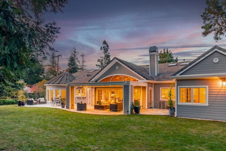 Nestled in one of North Los Altos most prestigious neighborhoods, this luxury home sits on nearly half an acre of private, park-like grounds. Designed for elegance and modern comfort, it offers 5 bedrooms and 4.5 bathrooms across 4,235 sq ft of living space, plus a 581 sq ft finished lower level - a perfect blend of craftsmanship, sophistication, and warmth. The great room features soaring ceilings and French doors to a covered outdoor living area, creating seamless indoor-outdoor flow. The chef's kitchen is a masterpiece with granite countertops, high-end appliances, and custom cabinetry, while formal dining and media rooms make entertaining effortless. The primary suite is a peaceful retreat with a marble spa bath and private patio. Four additional bedrooms, a custom home office, and a flexible lower level provides ideal space for family, work, and recreation. Outside, enjoy a lush backyard oasis with towering redwoods, a level lawn, expansive patios, and a detached studio perfect for yoga, art, or a quiet escape. Moments from downtown Los Altos, shops, dining, and top-rated schools, this home defines California luxury living.