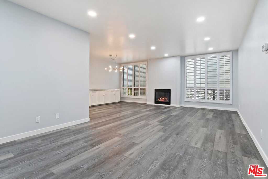 This beautiful first floor unit is right in the heart of West Hollywood and is in walking distance to restaurants, shops, grocery stores, parks and nightlife. Kings Road is lined with mature trees and lush landscaping and is a great place for a walk to the local farmer s market. This large 964 Sqft unit has an open floor plan with a gas fireplace as the warm and welcoming centerpiece of this home. Shutters on all the windows and built-in bookcases add character and charm. The cocktail bar also makes this a perfect home for entertaining. The roomy bathroom has 2 sinks, a stand alone shower and a separate bathtub. The bedroom has plenty of room for a king size bed and the large walk-in closet is perfect for a couple. There is a linen closet as well as a deep entry way closet. The building's HOA includes EQ insurance, trash, gas, basic cable and maintenance. This unit even comes with 2 side-by-side parking spaces. It is a pet friendly building too! You can step out and enjoy all that WeHo has to offer or just relax and unwind by the pool and enjoy your luxury home!
