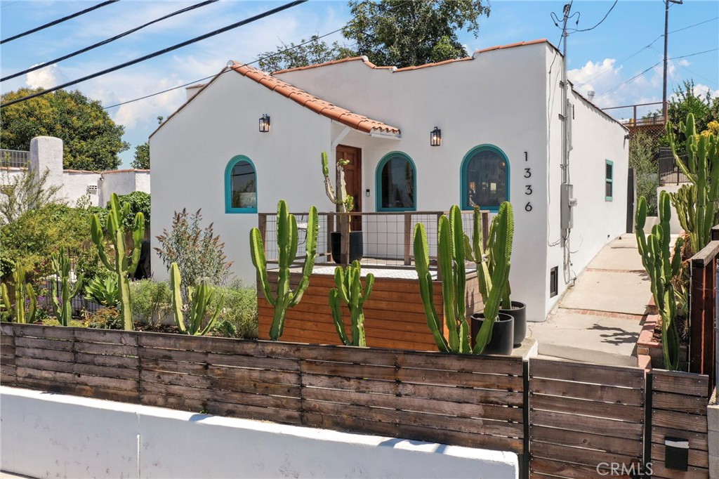 Nestled atop a serene hill on a spacious street-to-street double lot in the highly sought-after City Terrace neighborhood—just minutes from Downtown Los Angeles—this fully gated urban retreat offers unparalleled privacy and tranquility. This meticulously restored 2 bedroom, 2 bathroom home has been completely revitalized from the ground up, featuring a new foundation and thoughtfully upgraded systems including modern plumbing, electrical wiring, a 200-amp electrical panel, and a partial sewer line replacement. Newer windows and newer roof with high-efficiency mini-split system, ensuring both comfort and peace of mind. With a vision to honor its original Spanish charm, this home showcases elegant architectural details such as beautiful archways and custom arched wood windows. Each bathroom is adorned with stunning encaustic cement tiles, while the spacious open-concept living and dining area boasts wide plank oak floors and a stylish kitchen featuring Zia zellige tiles, quartz counters, and top-of-the-line LG stainless steel appliances—creating an ideal setting for both entertaining and relaxation. Enter through French doors to discover a private back patio that doubles as a secret garden, complete with a custom-built bench accented by decorative Spanish tiles—an inviting space for gatherings around the fire pit. Surrounded by olive trees, mature agaves, vibrant sage and lavender, and cacti (all equipped with a drip irrigation system), this outdoor oasis invites you to dine alfresco and savor the essence of Southern California living. Venture to one of the home's decks, each providing ample storage beneath, and take in the breathtaking panoramic views of the Hollywood sign and Griffith Observatory, alongside spectacular sunset vistas. The property is fully fenced and features a new automatic gate, offering rare parking for two cars within this vibrant community. Both bedrooms are generously sized, filled with natural light, and the primary suite features a walk-in closet and a luxurious en suite bath with a dual vanity and an oversized walk-in shower. Conveniently located near Cal State LA, USC Keck, major freeways, and the cultural offerings of DTLA, South Pasadena, and Hollywood, this property truly stands out. Property qualifies for a community lending program through Insignia Mortgage, offering rates as low as 5.8% on a 30-year fixed mortgage with just 10% down for loans up to $1M. For inquiries, please contact scott@scottsealey.com