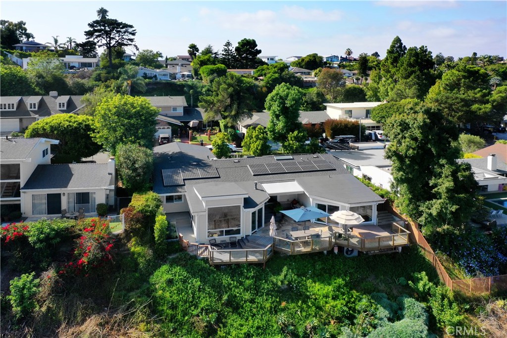 Discover this beautifully remodeled single-level home, perfectly positioned on one of the most desirable and quiet cul-de-sacs in the coveted Top of the World neighborhood. From its elevated perch, enjoy sweeping panoramic views spanning the Saddleback Valley to San Diego County, with a touch of ocean in the distance—the sparkling evening lights are truly breathtaking. The residence offers 3 bedrooms, an office with a closet (which could be a 4th bedroom) and three bathrooms. An airy, open floor plan with soaring ceilings creates a sense of volume and flow, anchored by a gourmet chef’s kitchen with LG and Wolf appliances, a spacious center island, and a built-in breakfast bar. Rich old-growth Hickory wood floors and custom Walnut cabinetry are complemented by thoughtfully placed skylights, filling the home with warmth and natural light. Outdoor living is effortless, with expansive deck space designed for entertaining and relaxation—complete with a barbecue area, al fresco dining, and a private spa overlooking a pristine natural canyon and those stunning views. Additional highlights include a walk-in pantry, air conditioning, a dedicated laundry room, a beautifully appointed two-car garage with EV charging, and a solar system for efficiency. Close to award-winning schools and parks, this property embodies the best of the Laguna Beach lifestyle.