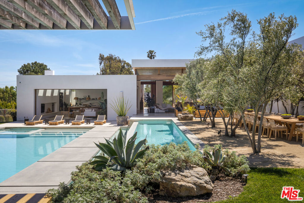 Discover a masterpiece of warm, modern architecture nestled in the heart of Point Dume, Malibu. This exceptional estate seamlessly blends indoor and outdoor living in a resort-style sanctuary/park sprawled across a pristine 1.7-acre parcel of land. With exclusive access to the Riviera 2 gate and a private beach key to Little Dume Beach, this is a rare opportunity to own ground-up new construction by the renowned Starchitects Standard Architecture, favored by celebrities worldwide. Imposing in scale yet inviting in atmosphere, this home sets the stage for unforgettable entertaining. Towering cedar-clad ceilings, expansive art walls, and exquisite finishes such as white oak and classic Italian travertine flooring create an ambiance of refined luxury. The kitchen and primary bath retreat boast imported Italian Calcutta and Mystery White stones, while Quantum's Afromosia wood sliding pocket doors effortlessly blur the lines between inside and out. This exceptional property features 5 bedrooms, 8 bathrooms, a private guest house, and a wealth of amenities including two pools, seven fire features, a home theater, and a covered BBQ cabana complete with a full pool bathroom. State-of-the-art Crestron and Lutron automation, along with Bocci lighting and Cocoon fixtures, elevate the living experience to unparalleled heights. Custom white oak millwork adds a touch of elegance throughout. Located in the coveted Point Dume neighborhood, this enclave offers a timeless sense of community and tranquility. From surfing to leisurely strolls through the nearby nature preserve overlooking Big Dume Beach, every day presents an opportunity for adventure and relaxation. Embrace the ultimate in coastal living where every moment feels like a vacation.