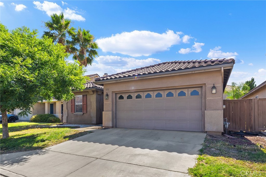 Located on the far west side outskirts of Hemet, this inviting single-story home sits at the end of a short cul-de-sac. The open and functional layout features a formal living and dining area, along with a spacious kitchen offering abundant cabinet and counter space that opens to the family room—perfect for both everyday living and entertaining. Tall ceilings throughout create a light, open, and airy feel. The thoughtful split floor plan offers privacy, with the primary bedroom and bathroom with dual sinks, step in shower, separate soaking tub, and walk in closet on one side of the home and two generously sized secondary bedrooms and full bathroom on the other. Step outside to a low-maintenance backyard with a small patio—ideal for relaxing or enjoying a quiet morning coffee. Additional highlights include a newer A/C and furnace (replaced in 2022), an indoor laundry room, low taxes, and a low HOA.