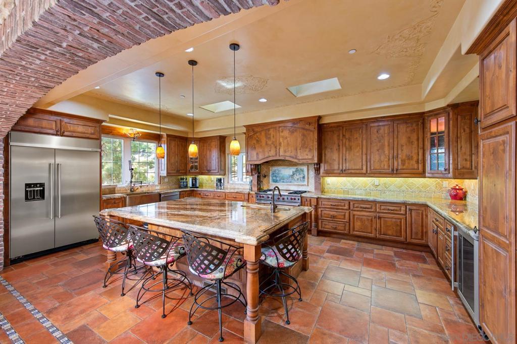 Welcome to this stunning 4,333 square foot, 3 bedroom, 2 bath, 2 half bath custom home in Palo Verde Ranch Alpine! Sitting atop 2.5 acres of beautiful oak and citrus trees, boulders, wild life and serene year round creek running through the property, this home is an outdoor enthusiasts dream or children's ultimate outside playground! It also hosts a two stall horse barn with plenty of space for parking and RV storage. The house itself is surrounded by beautifully stamped concrete, intimate solar lighting and irrigated succulent planters. This gorgeous home boasts a jaw-dropping entryway and inviting atrium with fireplace as the focal point upon entry. The exquisite attention to detail is evident throughout the entire house including copper sinks, Spanish tile floors, dual pane casement windows and custom cabinetry throughout. The chef's dream kitchen hosts a 40 sq.ft. island with copper sink, built in 48 inch refrigerator and WOLF range with double ovens, griddle, grill, and pot filler, as well as a built-in coffee maker and wine fridge! All three bedrooms are located on the first story with access to the grand balcony through french doors. The master bedroom features a his and hers walk in closet, thermostat controlled pellet stove, large walk in rain shower and jacuzzi soaking tub. Downstairs you'll find a beautiful spacious game room with wine cellar, fireplace, half bath, granite counter tops, dishwasher and sink. Being a homeowner in this exclusive neighborhood also gives you access to the private lake, gym and clubhouse amenities!