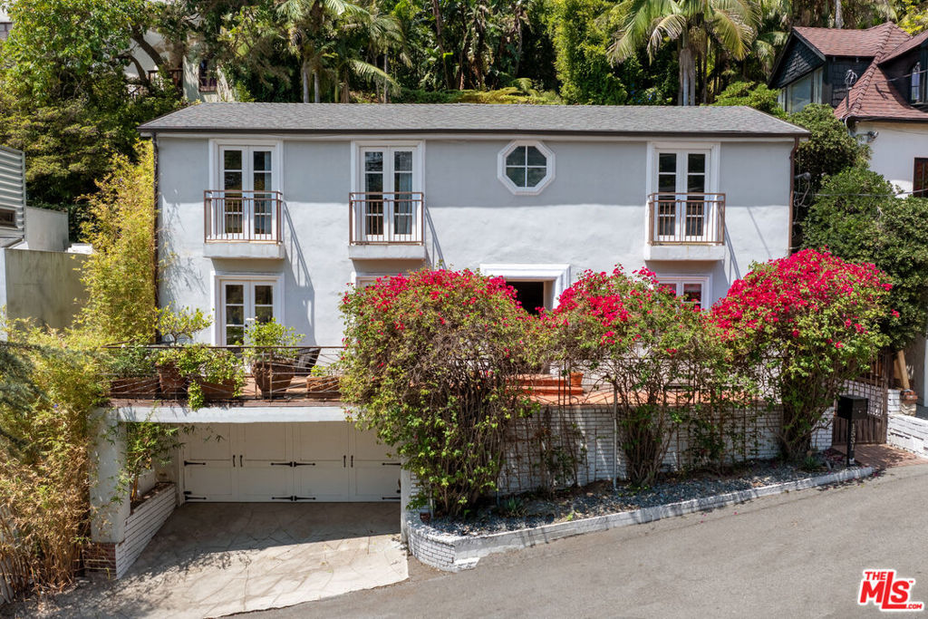 Perched in the Hollywood Hills just above the iconic Chateau Marmont and moments from the Sunset Strip, this stunning French-country residence embodies timeless elegance and celebrity-chic style. With panoramic city views from the primary suite, secondary bedroom, and the charming front patio, this home offers a serene escape in the heart of Los Angeles. Thoughtful 3-bedroom, 3-bathroom home featuring a gourmet kitchen, stylish finishes, and rich hardwood floors that flow through the light-filled interior spaces. The living and entertaining areas are warm and welcoming, perfect for both relaxed evenings and elegant gatherings. Step outside to a sun-drenched patio with a built-in fire place ideal for al fresco entertaining. Follow the backyard staircase to a private viewing platform at the top of the property, where unobstructed city vistas create a breathtaking backdrop.A true sanctuary in one of L.A.'s most historic and sought-after neighborhoods, this home is a rare blend of classic charm and modern luxury.